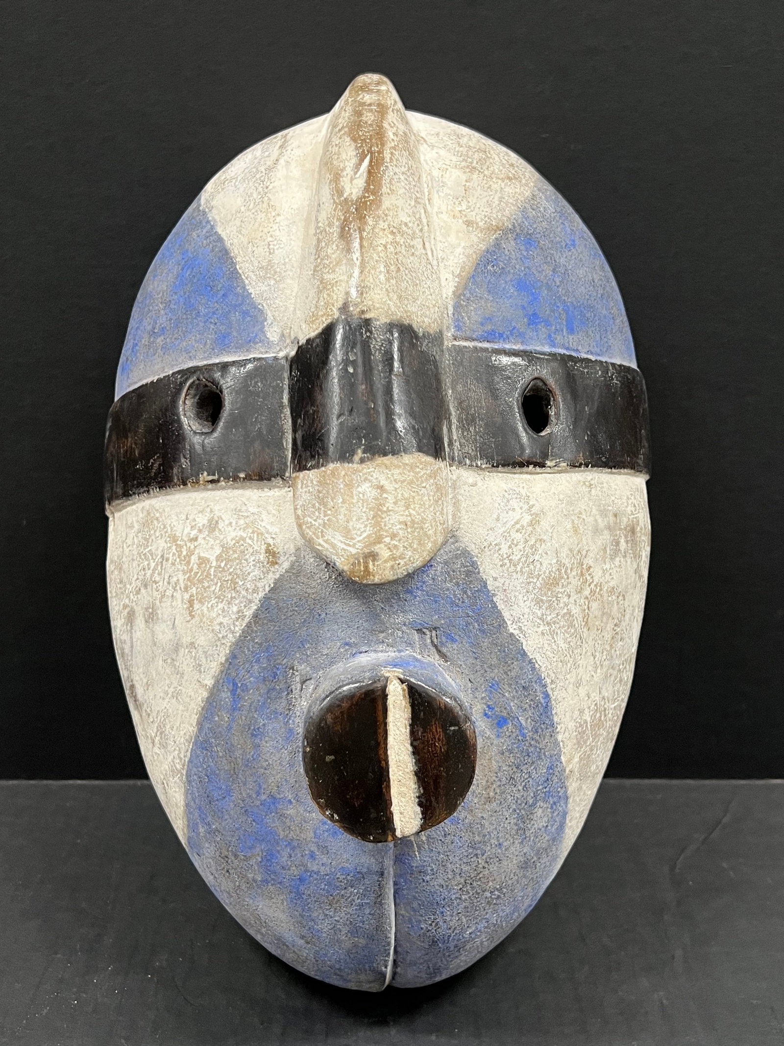 Carved Wood Bacongo Mask: African Tribal Art Carved Wood Bacongo Mask. The dimension is 14 inches high x 9 inches wide. Please be aware that some of the items are vintage, secondhand, old ages, antiques and may have a defects 