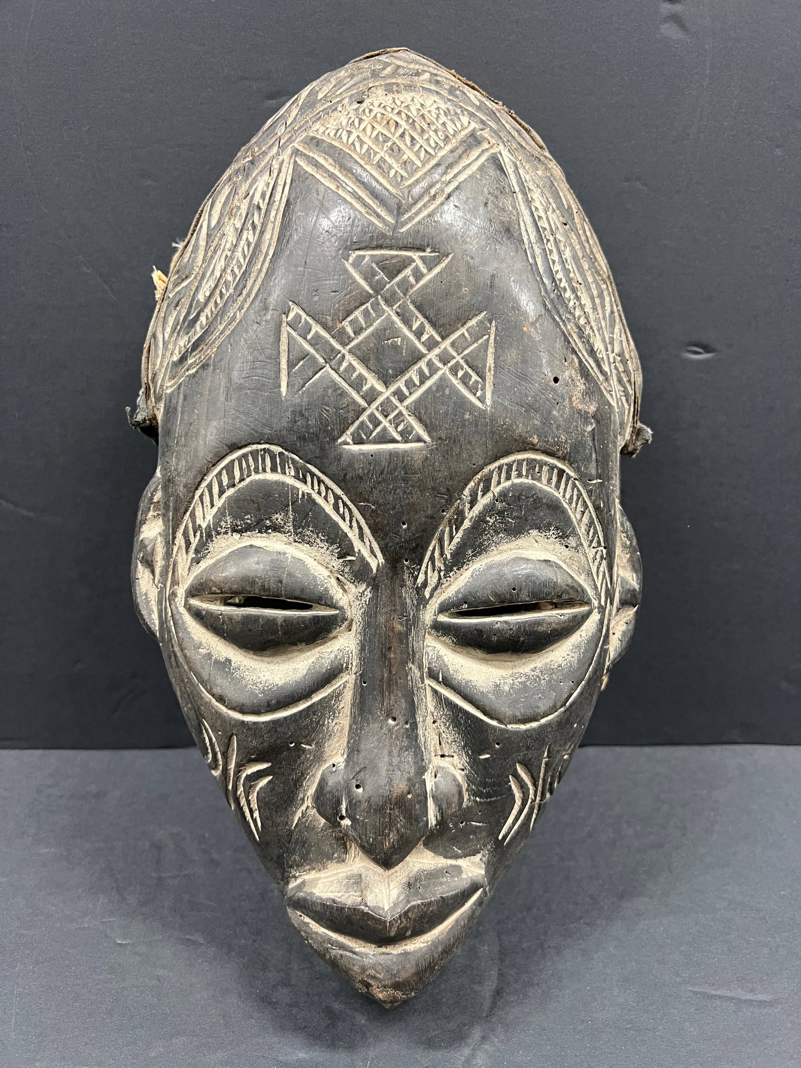 Carved Wood Chokwe Mask: African Tribal Art Carved Wood Chokwe Mask. The dimension is 13.5 inches high x 9 inches wide. Please be aware that some of the items are vintage, secondhand, old ages, antiques and may have a defects