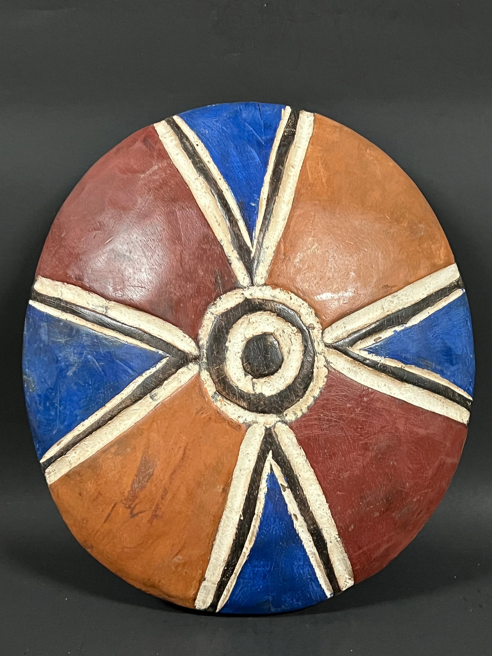 Carved Wood Zulu Shield: African Tribal Art Carved Wood Zulu Shield. The dimension is 11 inches high x 12 inches wide. Please be aware that some of the items are vintage, secondhand, old ages, antiques and may have a defects 