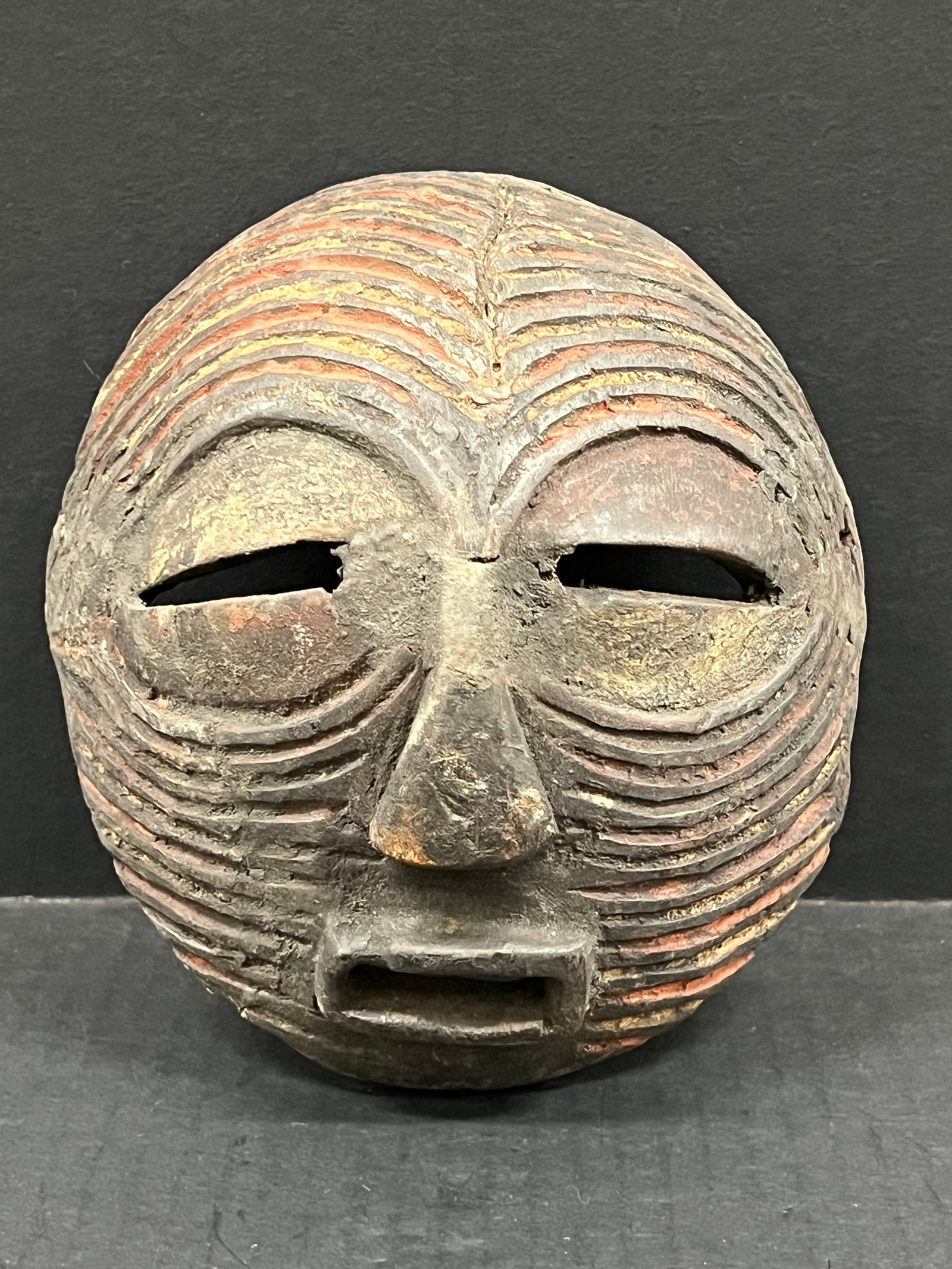 Carved Wood Basongye Mask: African Tribal Art Carved Wood Basongye Mask. The dimension is 7 inches high x 7 inches wide. Please be aware that some of the items are vintage, secondhand, old ages, antiques and may have a defects 