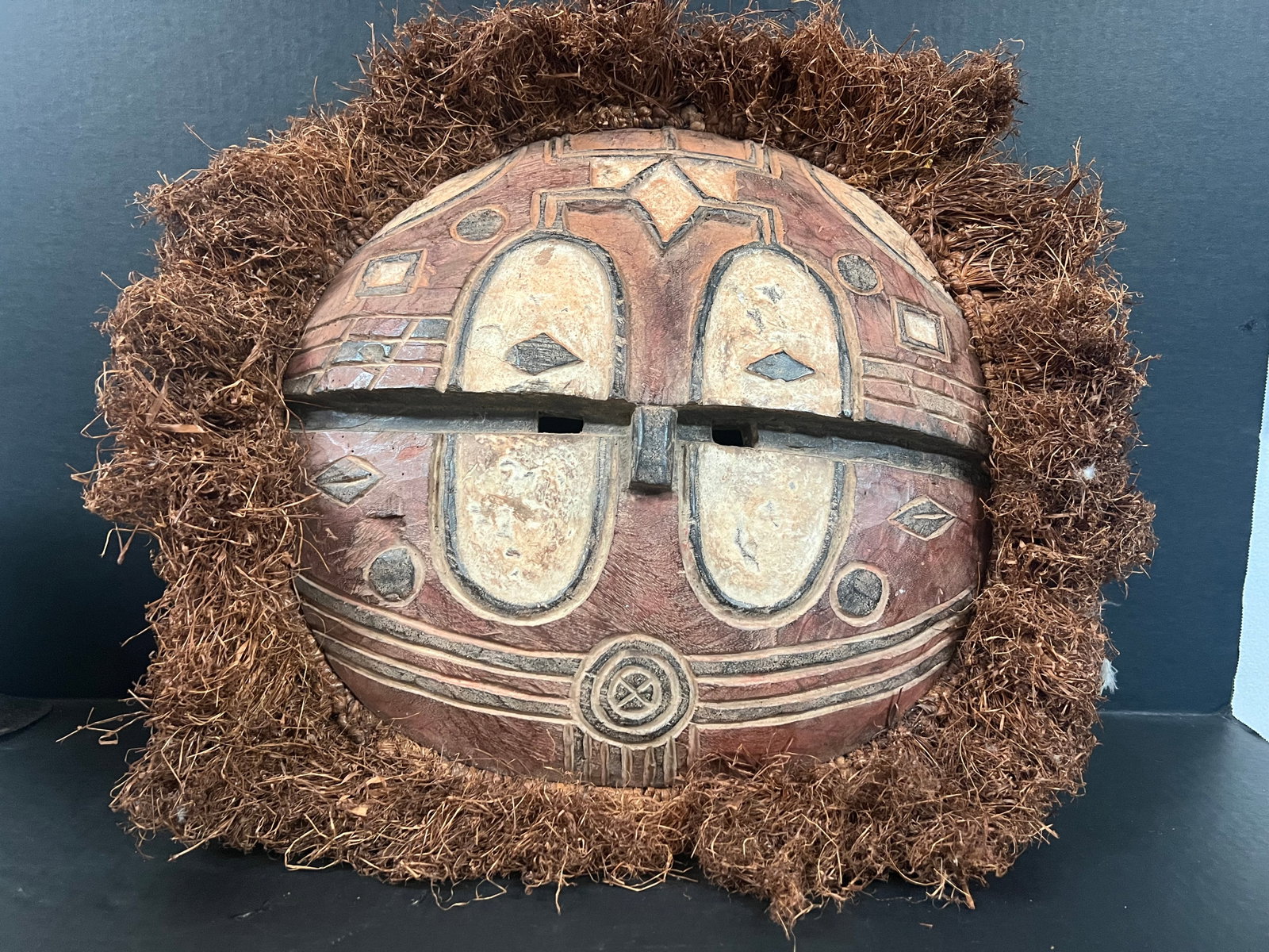 Carved Wood Teke Mask: African Tribal Art Carved Wood Teke Mask. The dimension is 14 inches high x 16 inches wide. Please be aware that some of the items are vintage, secondhand, old ages, antiques and may have a defects or