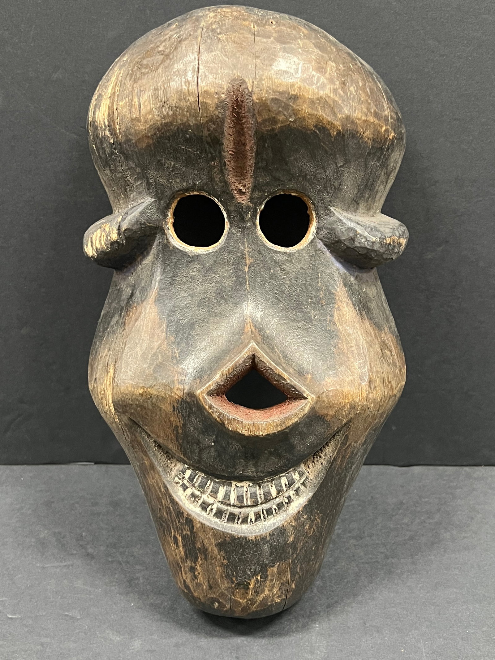 Carved Wood Skull Mask: African Tribal Art Carved Wood Skull Mask. The dimension is 12 inches high x 7 inches wide. Please be aware that some of the items are vintage, secondhand, old ages, antiques and may have a defects