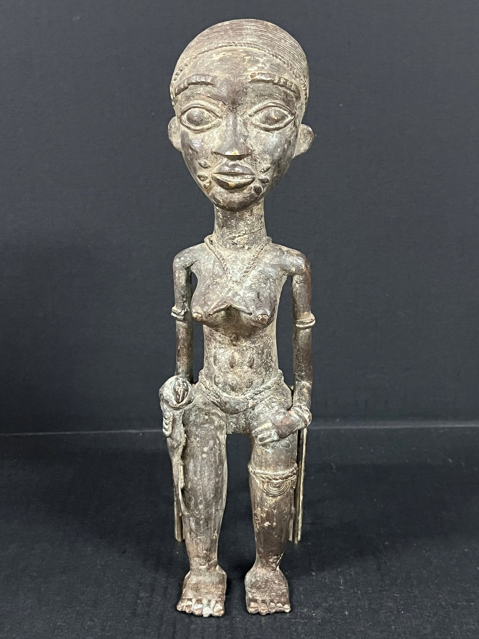 Benin Bronze Statue: African Tribal Art Benin Bronze Statue. The dimension is 13 inches high x 3.5 inches wide. Please be aware that some of the items are vintage, secondhand, old ages, antiques and may have a defects or 