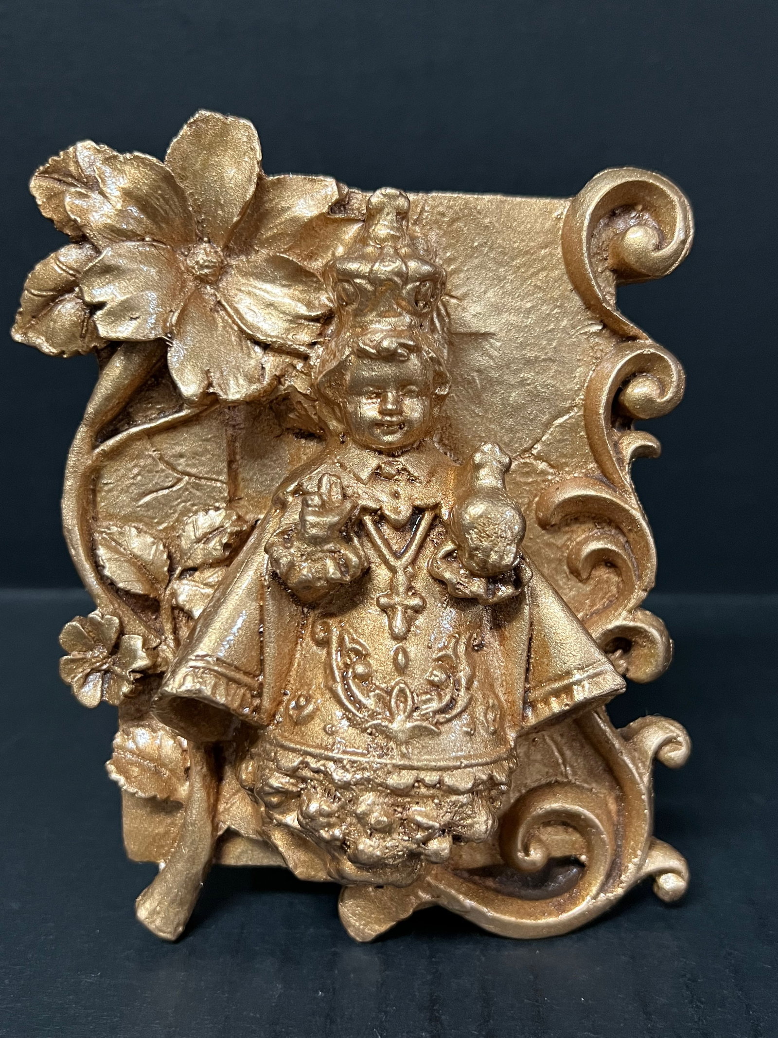 Philippine Cast Mount Pinatubo and Taal Volcano Ash Gold Painted Icon of Santo Nino: Religious Art Philippine Cast Mount Pinatubo and Taal Volcano Ash Gold Painted Icon of Santo Nino. The dimension is 5 inches high x 1.5 inches depth x 4.5 inches wide. Please be aware that some of the