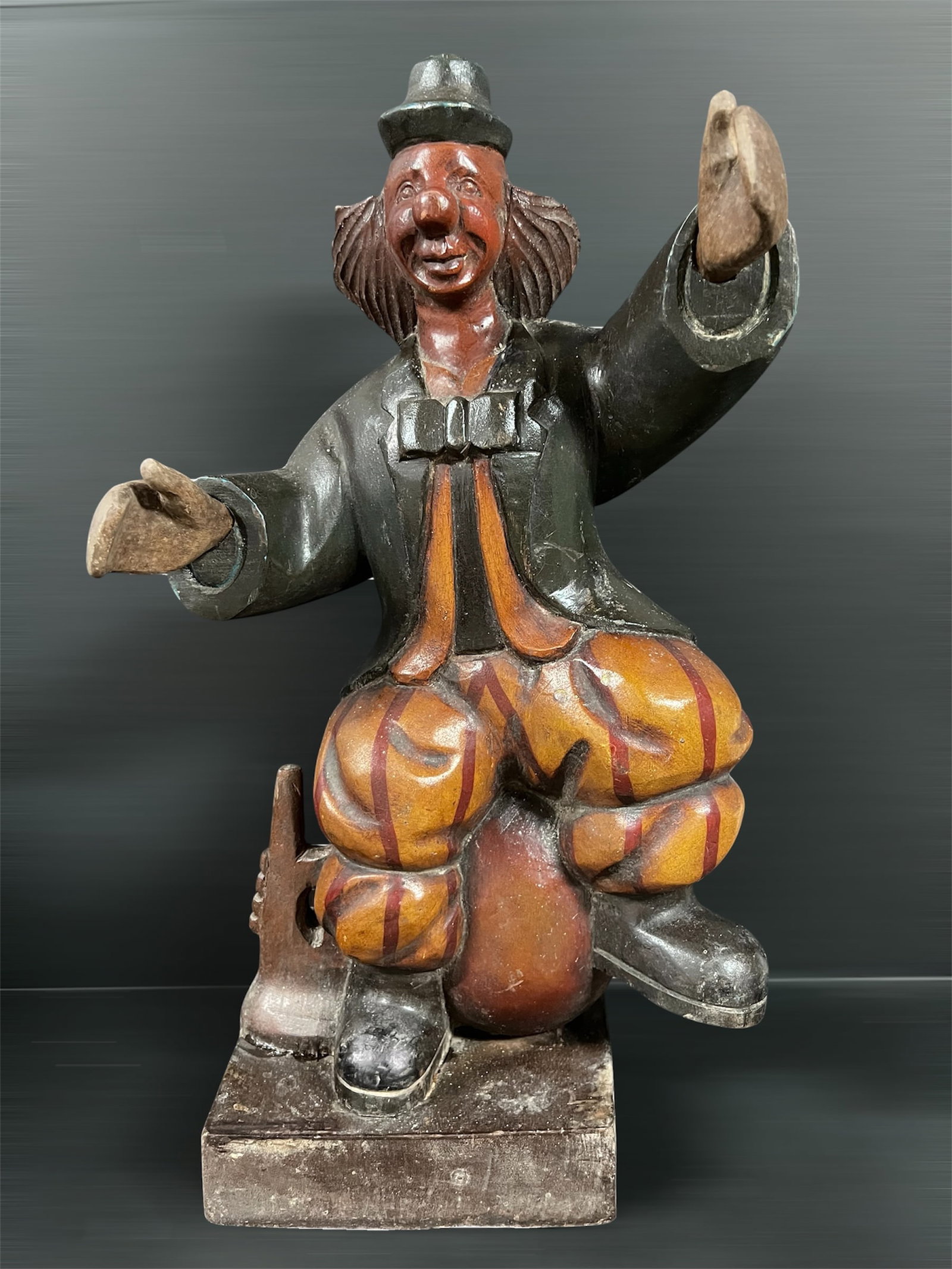 Carved Wood Clown: Folk Art Carved Wood Clown. The dimension is 21 inches high x 7 inches depth x 12 inches wide. Please be aware that some of the items are vintage, secondhand, old ages, antiques and may have a defects
