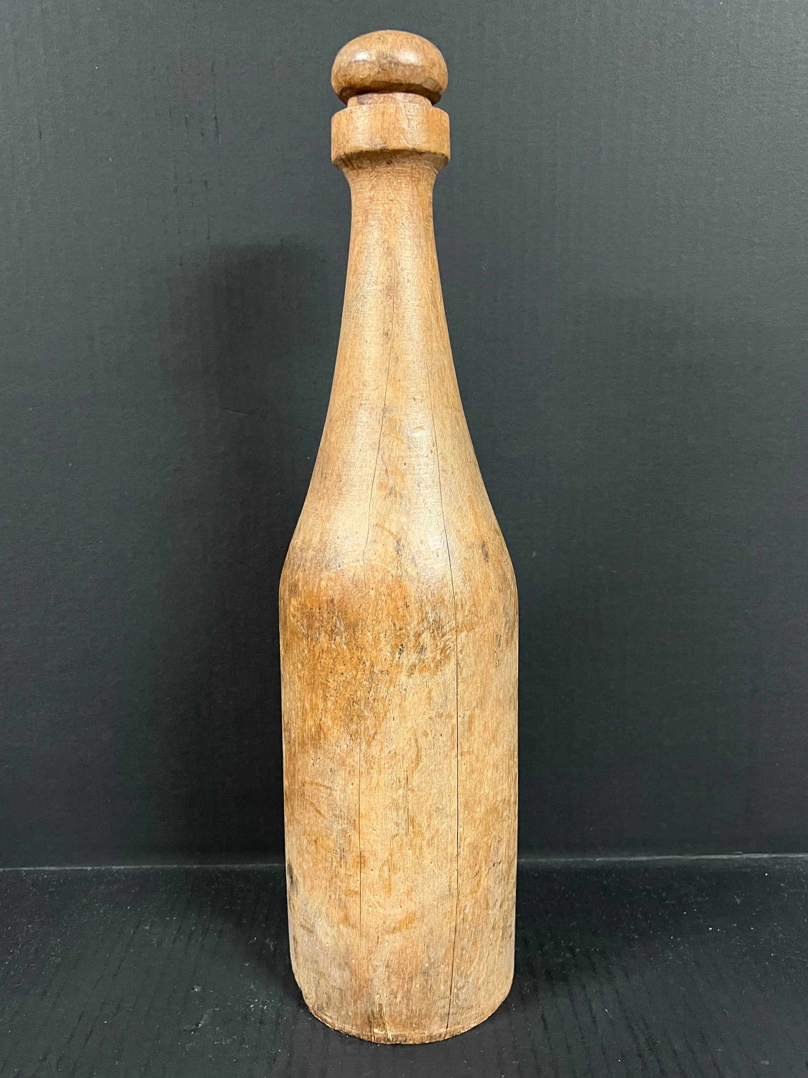 Carved Wood Wine Bottle: Folk Art Carved Wood Wine Bottle. The dimension is 18 inches high x 5 inches depth x 5 inches wide. Please be aware that some of the items are vintage, secondhand, old ages, antiques and may have a de