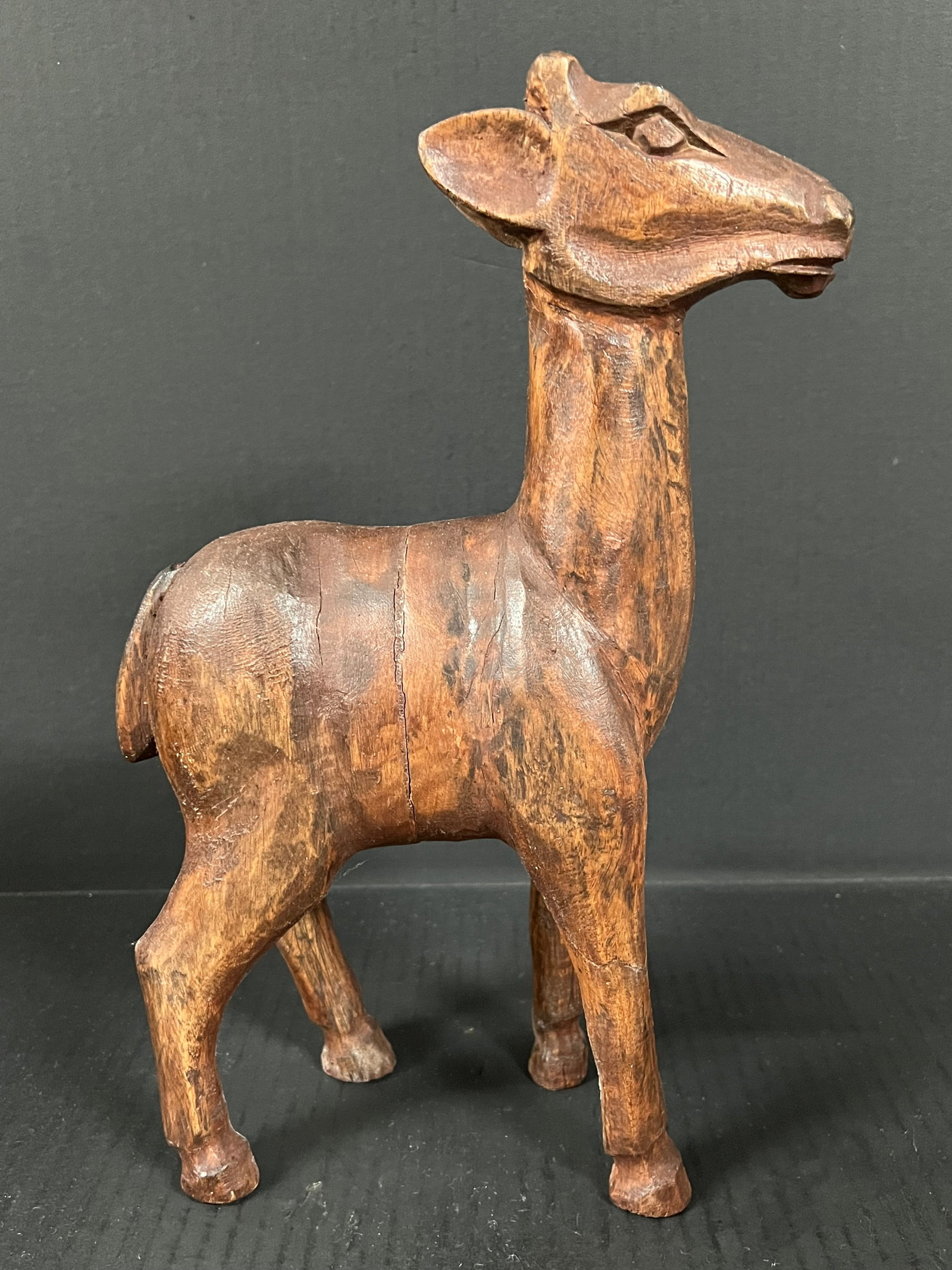Carved Wood Deer: Folk Art Carved Wood Deer. The dimension is 13.25 inches high x 3.5 inches depth x 8 inches wide. Please be aware that some of the items are vintage, secondhand, old ages, antiques and may have a