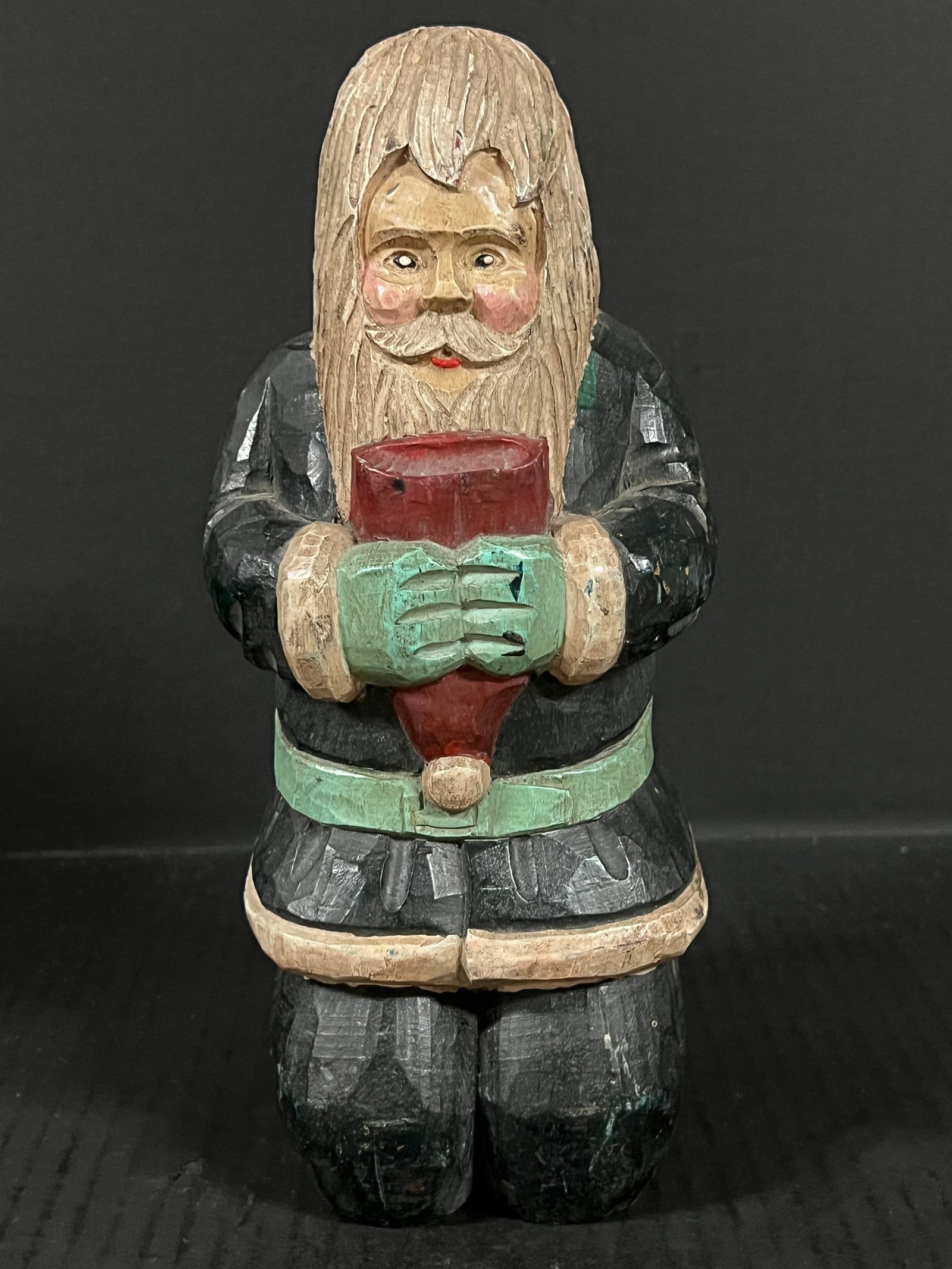 Carved Wood Santa Claus: Folk Art Carved Wood Santa Claus. The dimension is 10 inches high x 4 inches depth x 4 inches wide. Please be aware that some of the items are vintage, secondhand, old ages, antiques and may have a
