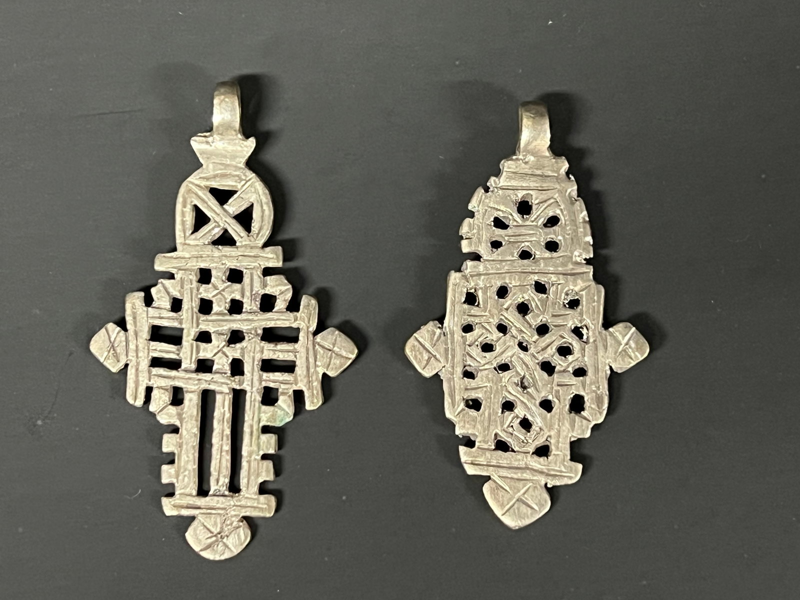 Ethiopian Metal Coptic Cross Pendant 2 Pcs.: African Tribal Art Ethiopian Metal Coptic Cross Pendant 2 Pcs. The dimension is 3.25 inches high x 2.25 inches wide. Please be aware that some of the items are vintage, secondhand, old ages, antiques 