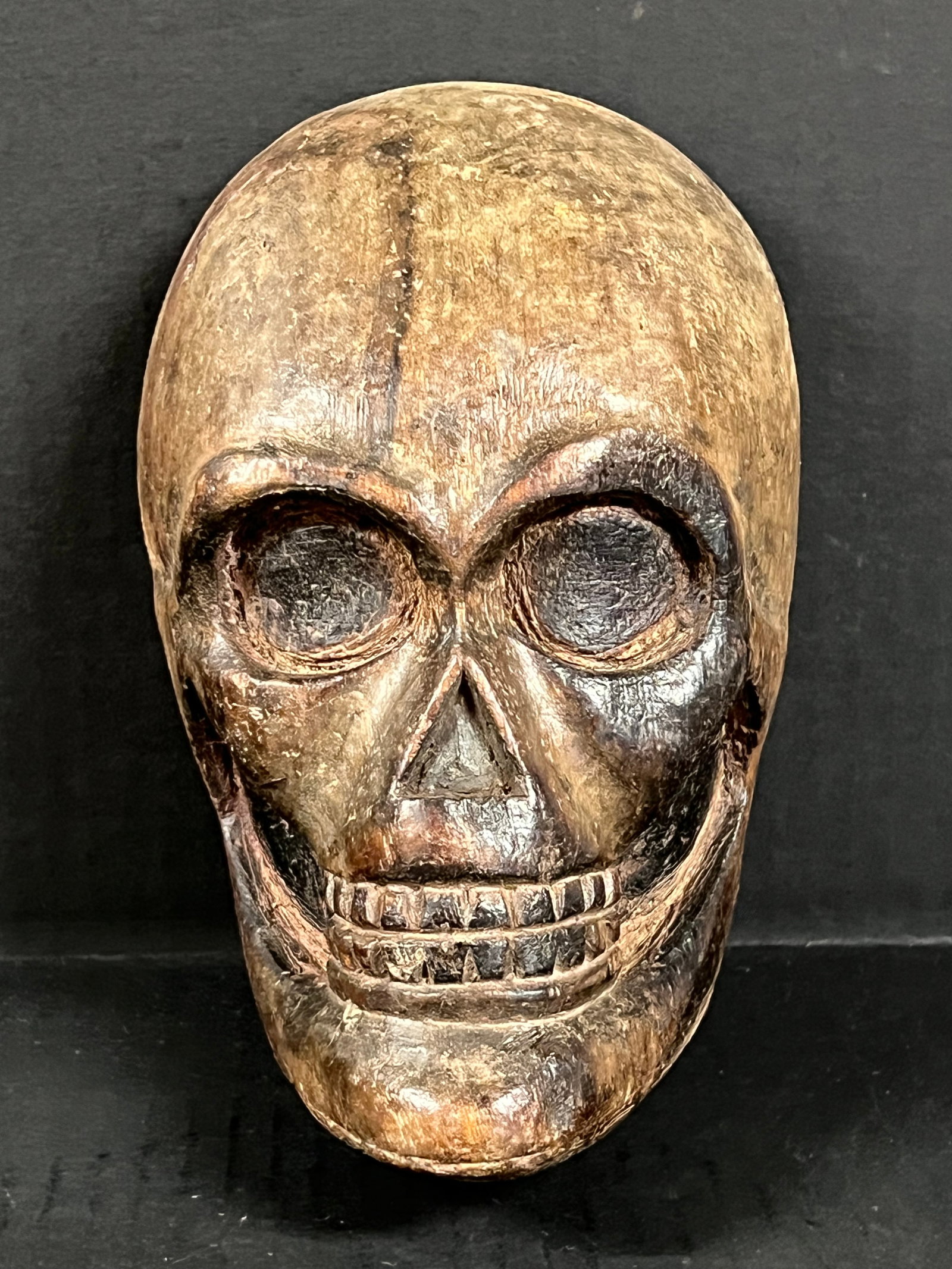 Carved Wood Skull Face Plaque: Folk Art Carved Wood Skull Face Plaque. The dimension is 8 inches high x 5.25 inches wide. Please be aware that some of the items are vintage, secondhand, old ages, antiques and may have a defects or 