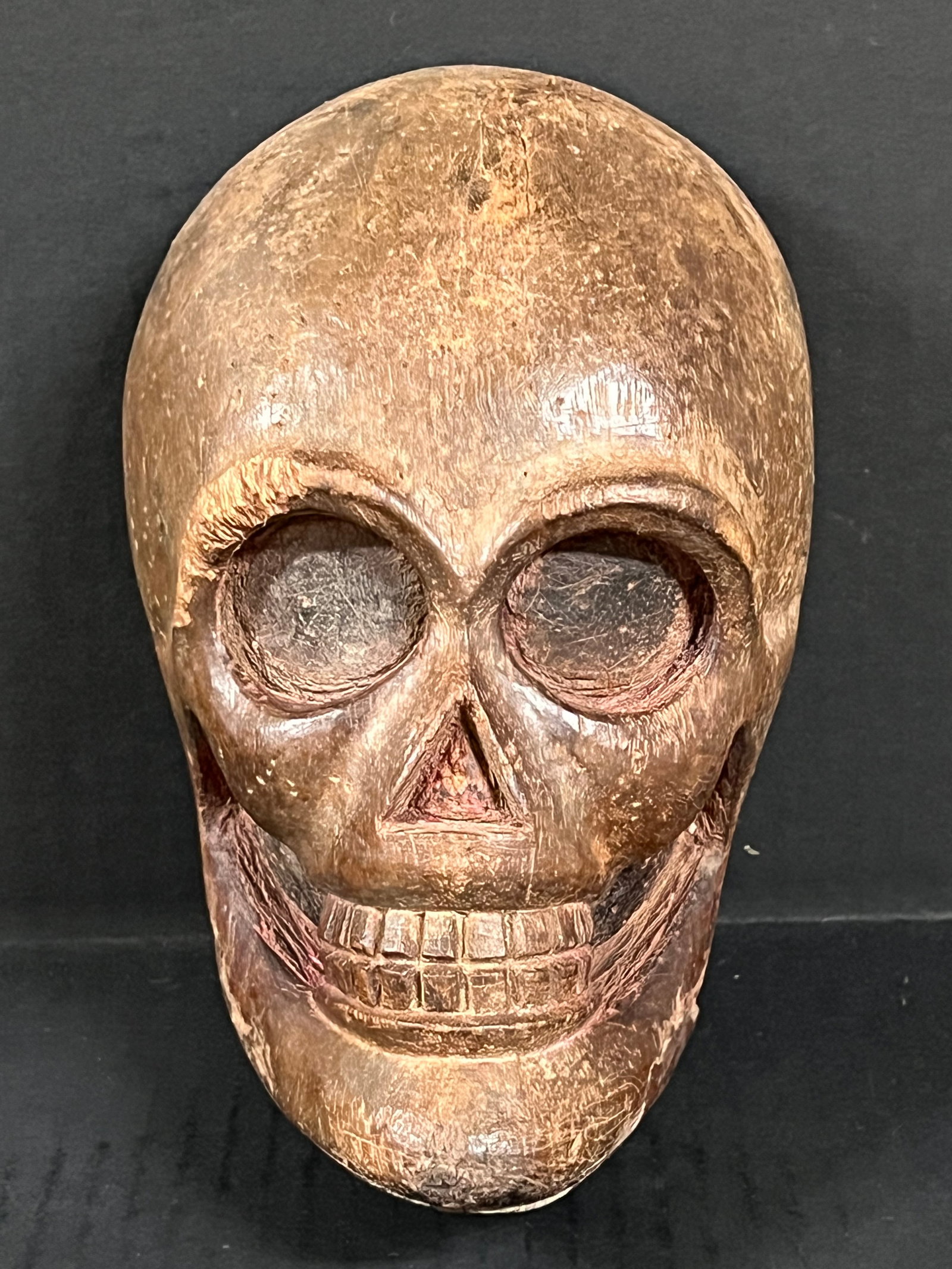 Carved Wood Skull Face Plaque: Folk Art Carved Wood Skull Face Plaque. The dimension is 8 inches high x 5.25 inches wide. Please be aware that some of the items are vintage, secondhand, old ages, antiques and may have a defects or 