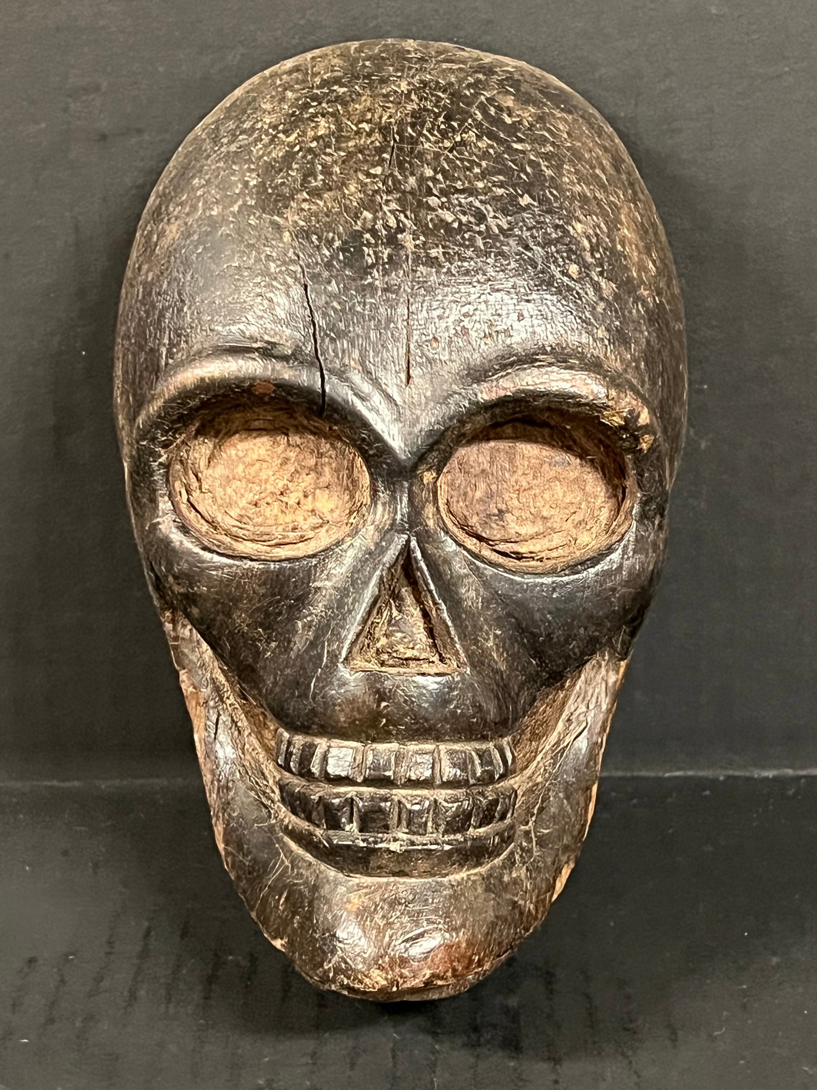 Carved Wood Skull Face Plaque: Folk Art Carved Wood Skull Face Plaque. The dimension is 8 inches high x 5.25 inches wide. Please be aware that some of the items are vintage, secondhand, old ages, antiques and may have a defects or 