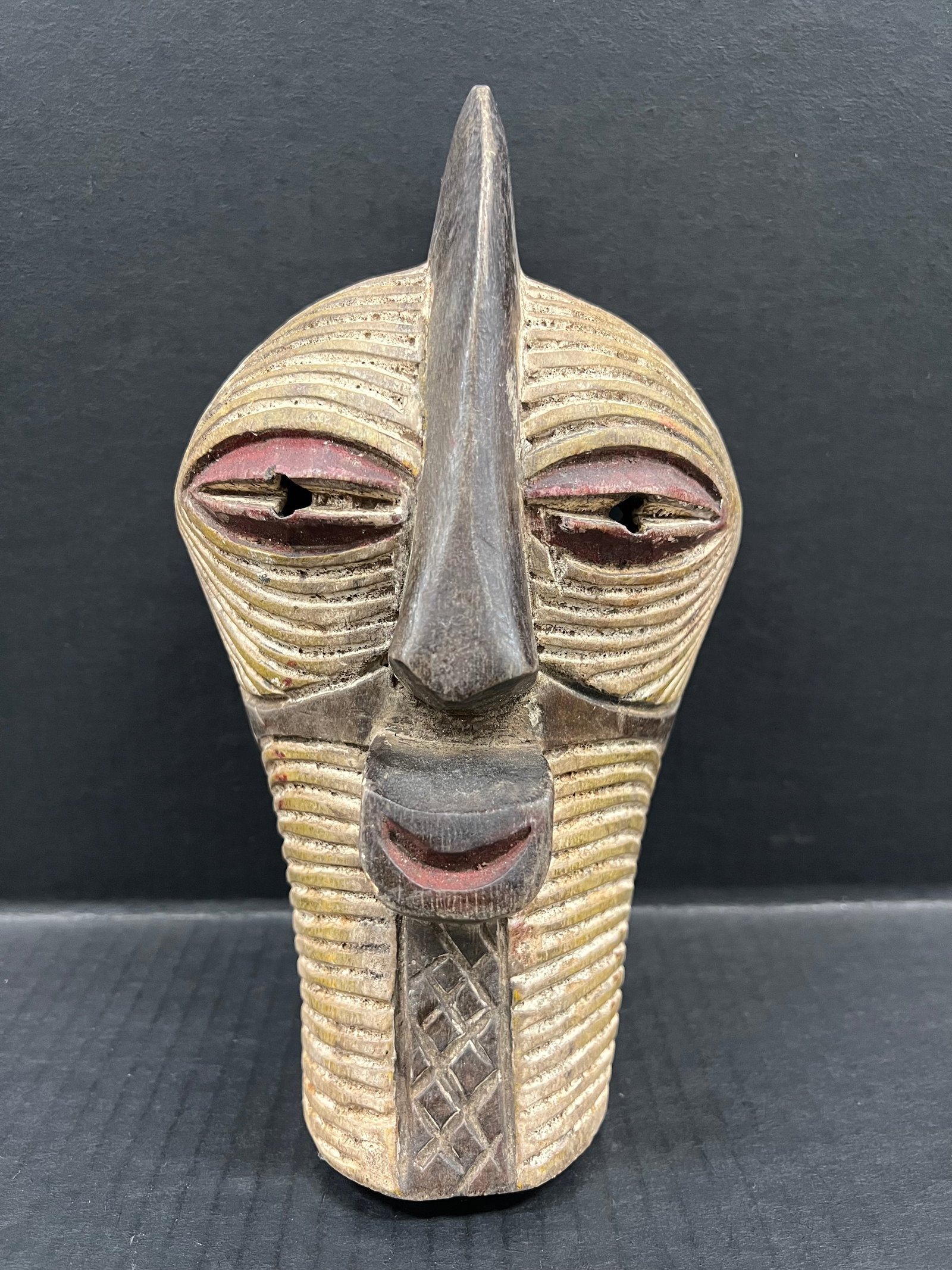 Carved Wood Songye Mask: African Tribal Art Carved Wood Songye Mask. The dimension is 10 inches high x 6 inches wide. Please be aware that some of the items are vintage, secondhand, old ages, antiques and may have a defects o