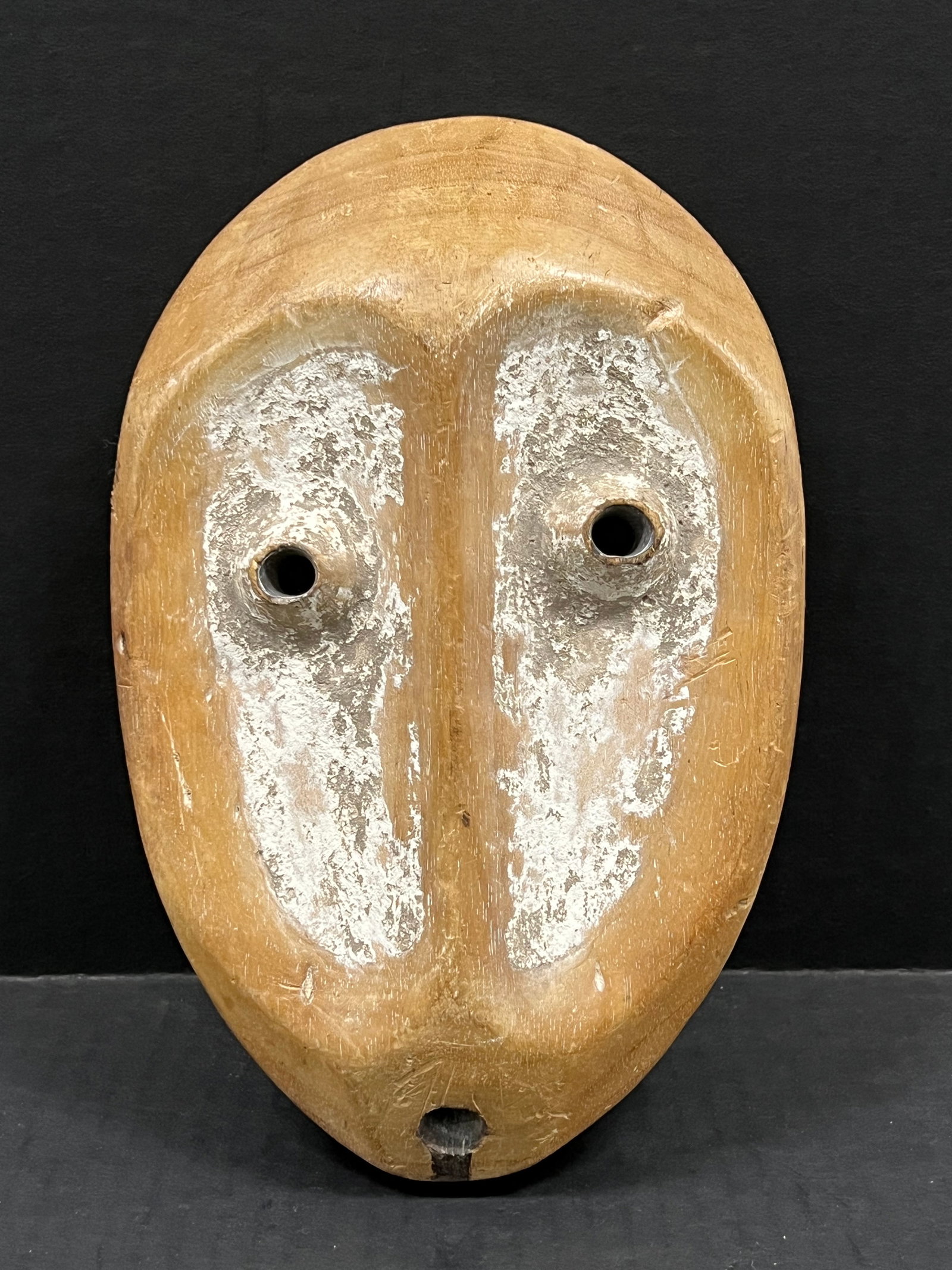 Carved Wood Lega Mask: African Tribal Art Carved Wood Lega Mask. The dimension is 9.5 inches high x 6.5 inches wide. Please be aware that some of the items are vintage, secondhand, old ages, antiques and may have a defects 