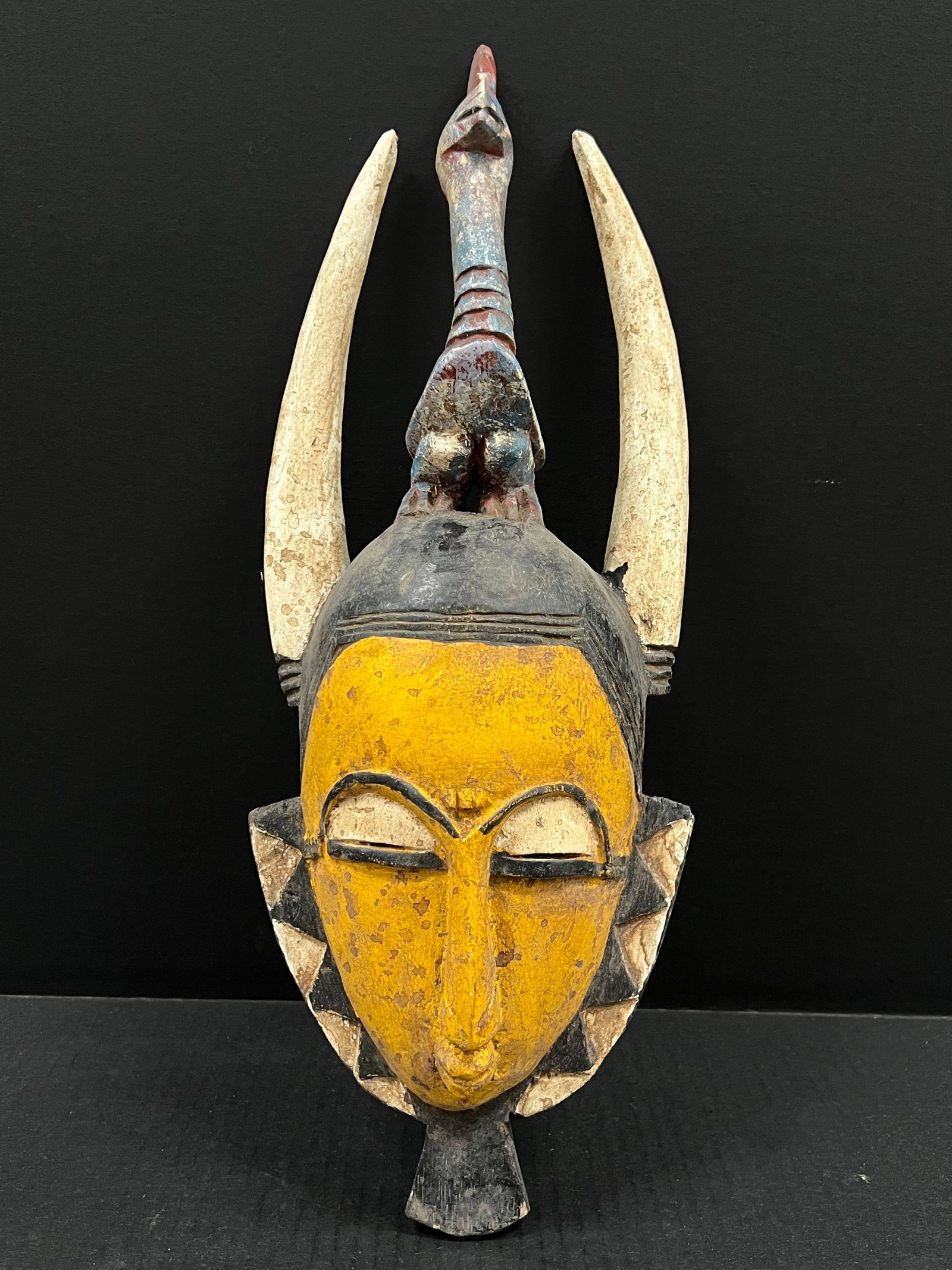 Carved Wood Guru Mask: African Tribal Art Guru Mask. The dimension is 18 inches high x 7 inches wide. Please be aware that some of the items are vintage, secondhand, old ages, antiques and may have a defects or sign of ages