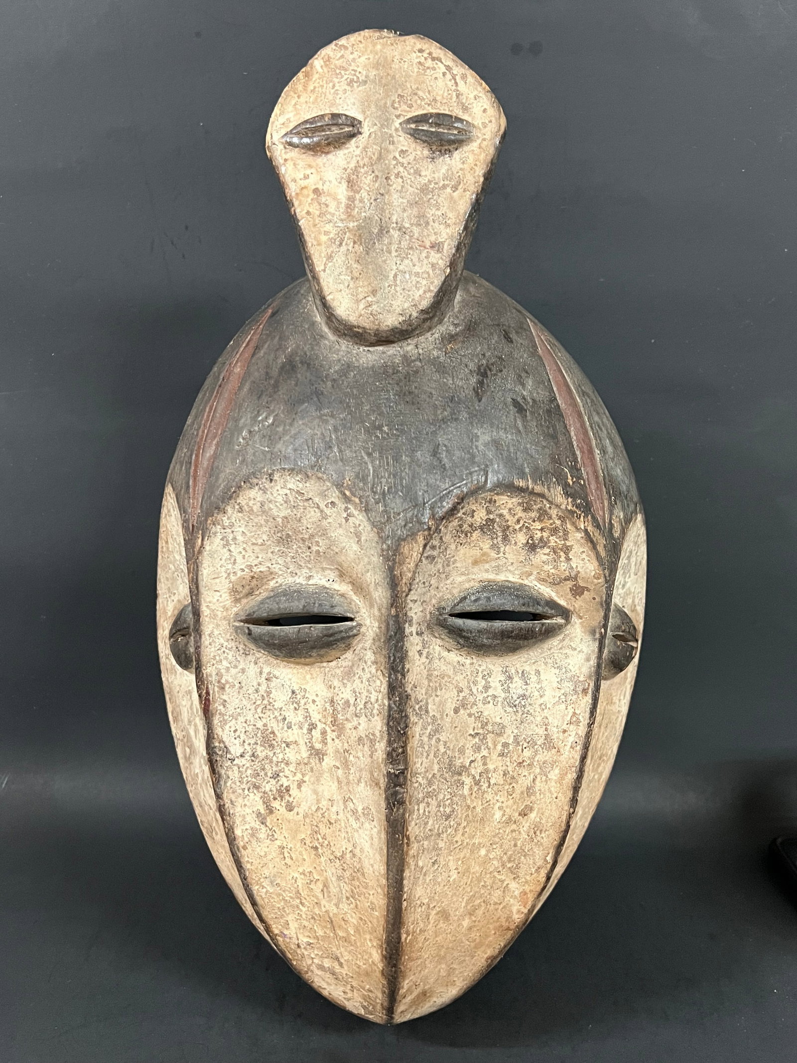 Carved Wood Multiple Face Lega Mask: African Tribal Art Multiple Face Lega Mask. The dimension is 17 inches high x 8.5 inches wide. Please be aware that some of the items are vintage, secondhand, old ages, antiques and may have a defects