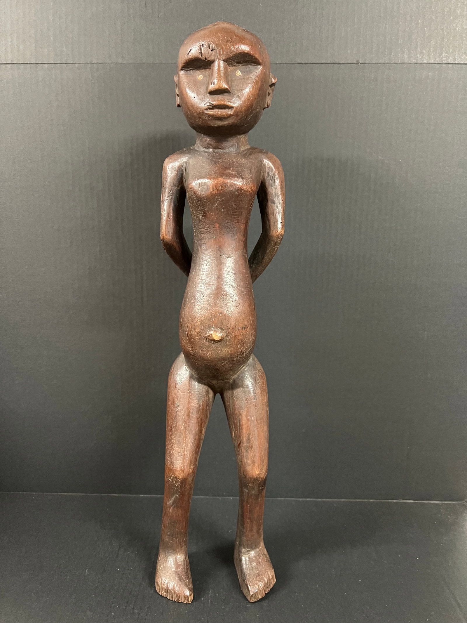 Carved Wood Tanzania Statue: African Tribal Art Tanzania Statue. The dimension is 24 inches high x 5.5 inches wide. Please be aware that some of the items are vintage, secondhand, old ages, antiques and may have a defects or sign