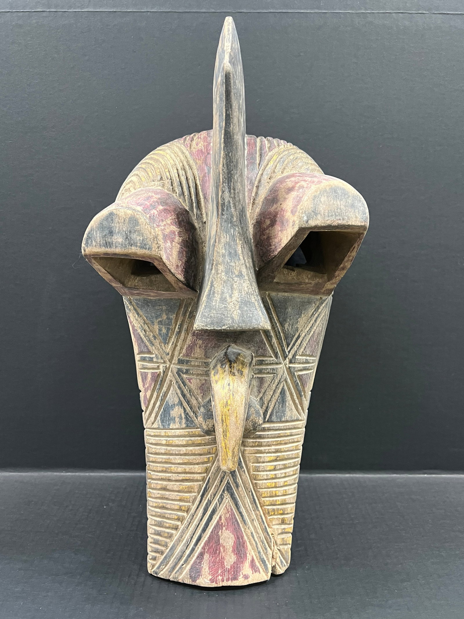 Carved Wood Songye Mask: African Tribal Art Songye Mask. The dimension is 22 inches high x 9.5 inches wide. Please be aware that some of the items are vintage, secondhand, old ages, antiques and may have a defects or sign of 