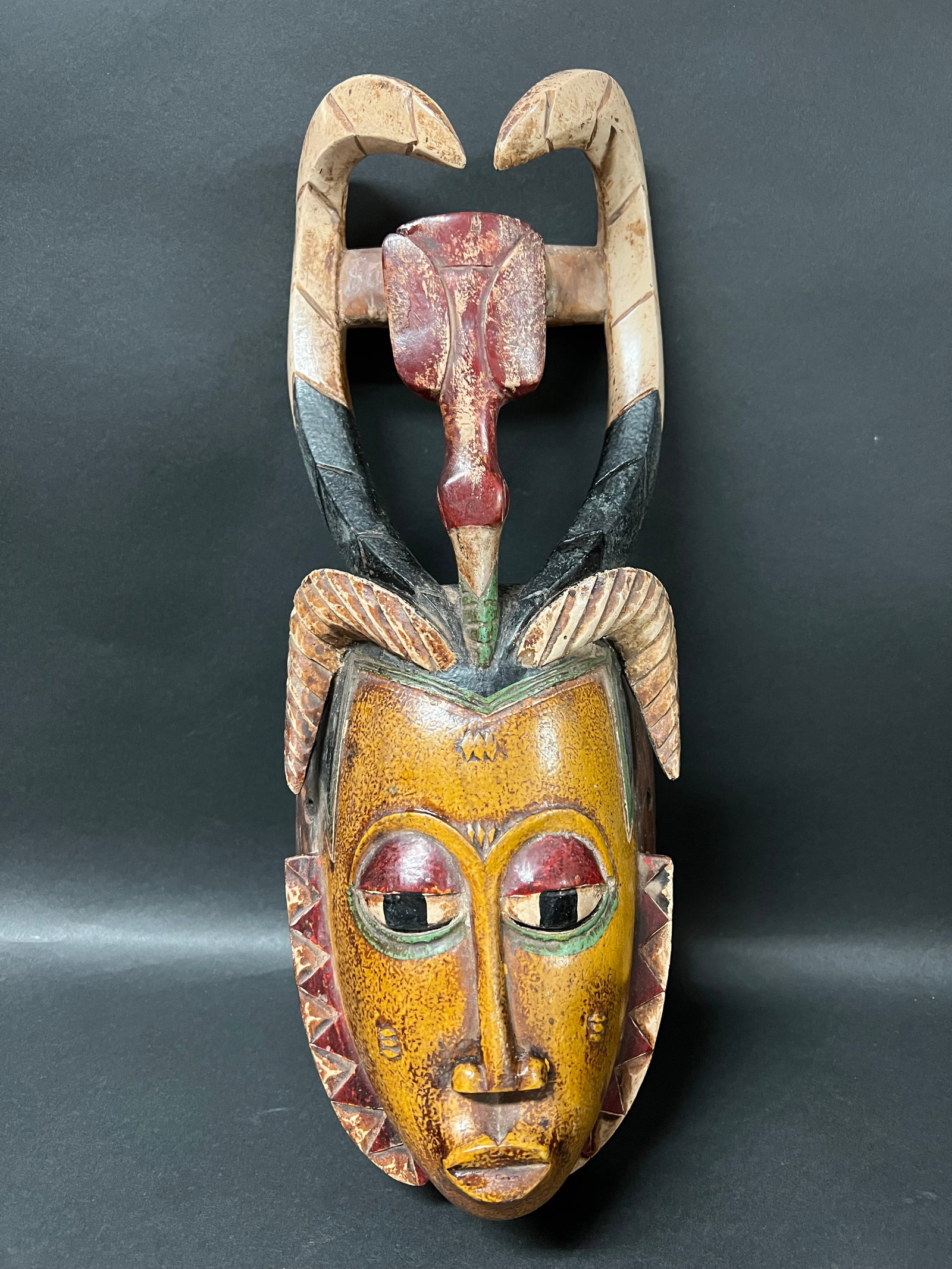 Carved Wood Guru Mask: African Tribal Art Guru Mask. The dimension is 15.5 inches high x 6 inches wide. Please be aware that some of the items are vintage, secondhand, old ages, antiques and may have a defects or sign of ag
