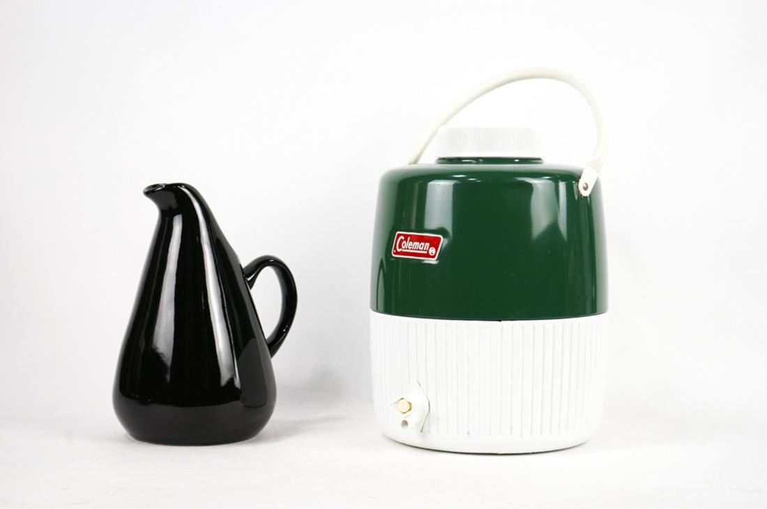 Vintage Coleman Cooler and Russel Wright Pitcher: Russell Wright cooler made by Oneida from China. Vintage Coleman cooler made in Wichita Kansas is a 2 gallon unit in fairly good condition. A couple of surface scratches on the green paint and a semi-
