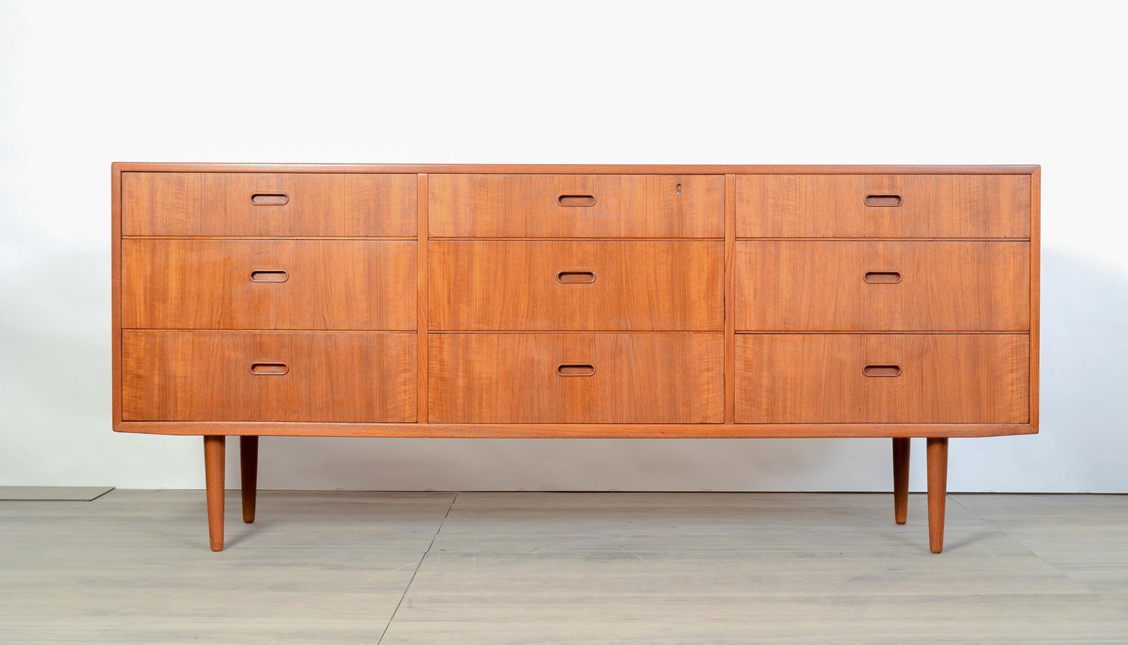 Falster Teak Dresser: Falster Teak Dresser designed by Arne Vodder.Has been lightly restored. Missing the lock and key but retains the lock hole. Measures 72” wide, 17” deep, and 31” tall.