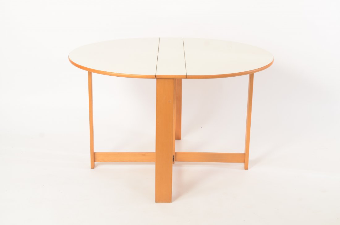 White Formica Drop Leaf Table: 31" wide x 28" tall, 46" in diameter when open and 6" deep when folded flat.