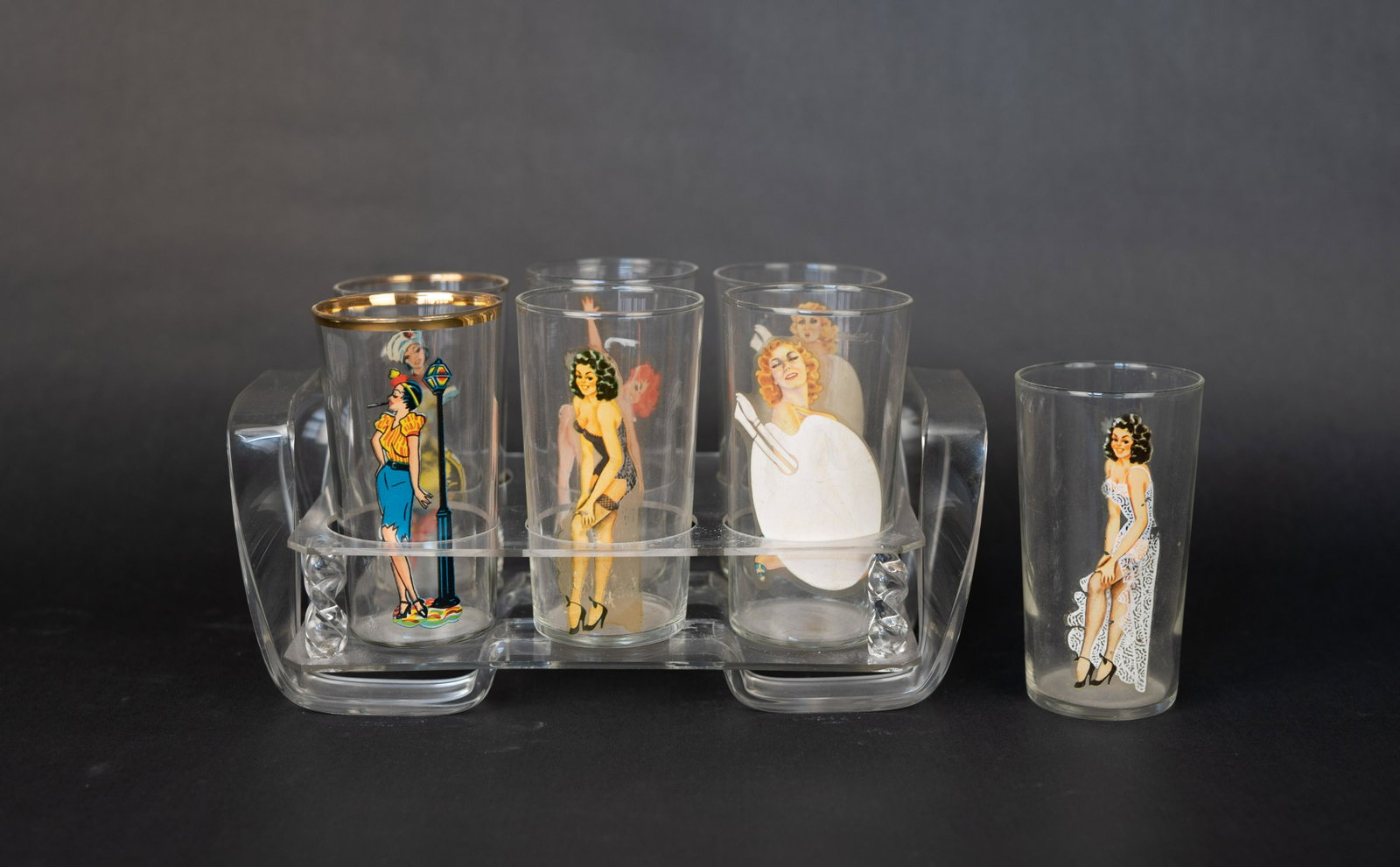 7 Peekaboo Pin-Up Girl Glasses: Lot includes 7 glasses (two with gold rim) and a clear lucite tray which holds 6 glasses. Two glasses are nude on the inside of the glass.