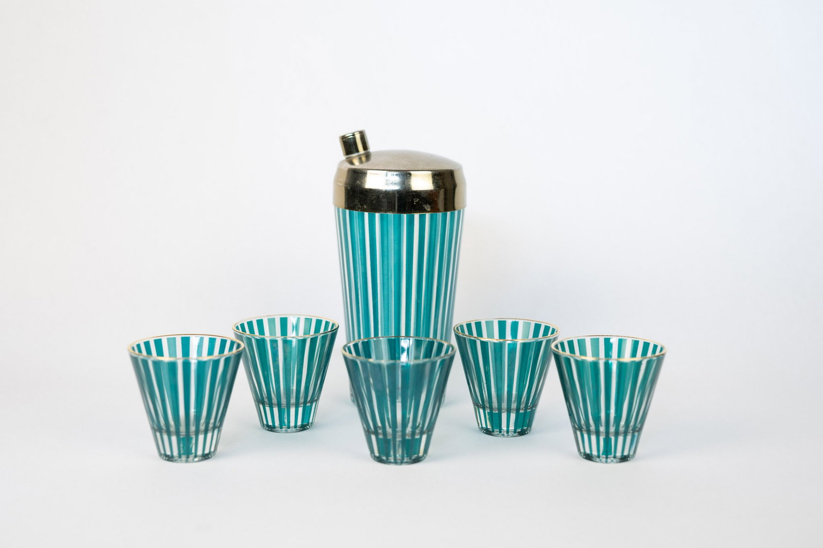 MCM Teal Stripe Cocktail Glass Set: Original vintage 1950s-1960s MCM cocktail shaker set with five glasses with vertical teal stripes. Includes 5 glasses with gold rims and one cocktail shaker.