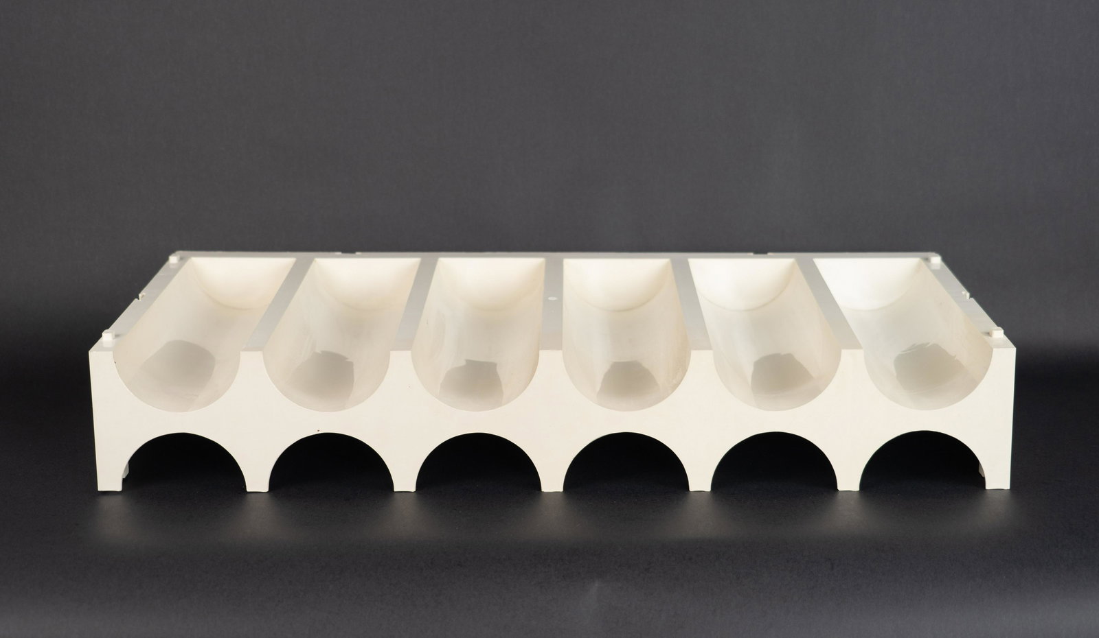 Joe Colombo Attri. Space Age Atomic Wine Bottle Shelf in White: Joe Colombo attributed. Can be stacked with additional pieces. Measures 25.35 inches wide, 11.75 inches deep and 4.15 inches tall.