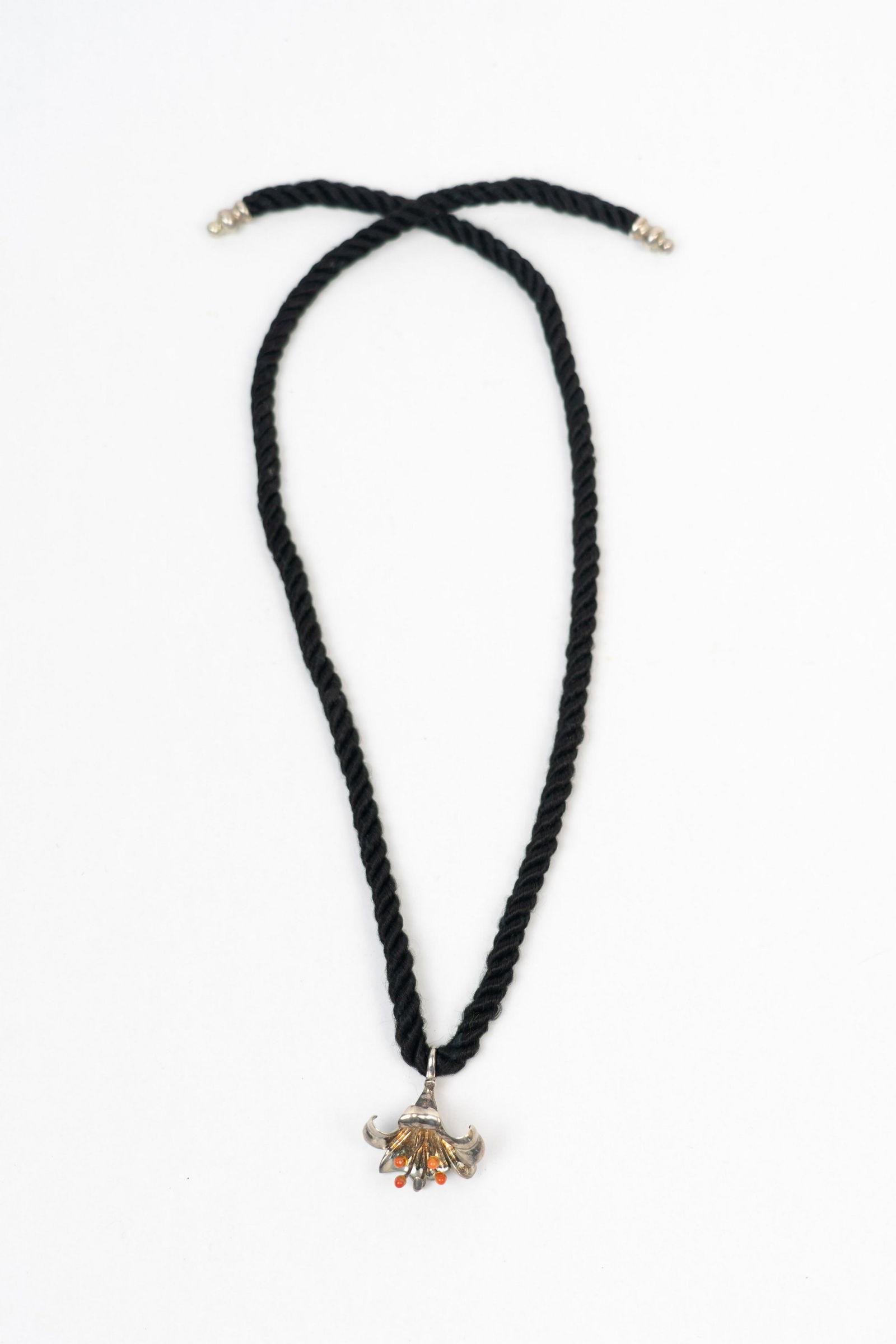 Charles Krypell Sterling Silver Flower Pendant Necklace: Flower pendant is signed by the artist C. Krypell, marked Sterling. Red stone used for anthers, possibly carnelian. Soft cord for chain, can be tied closed.