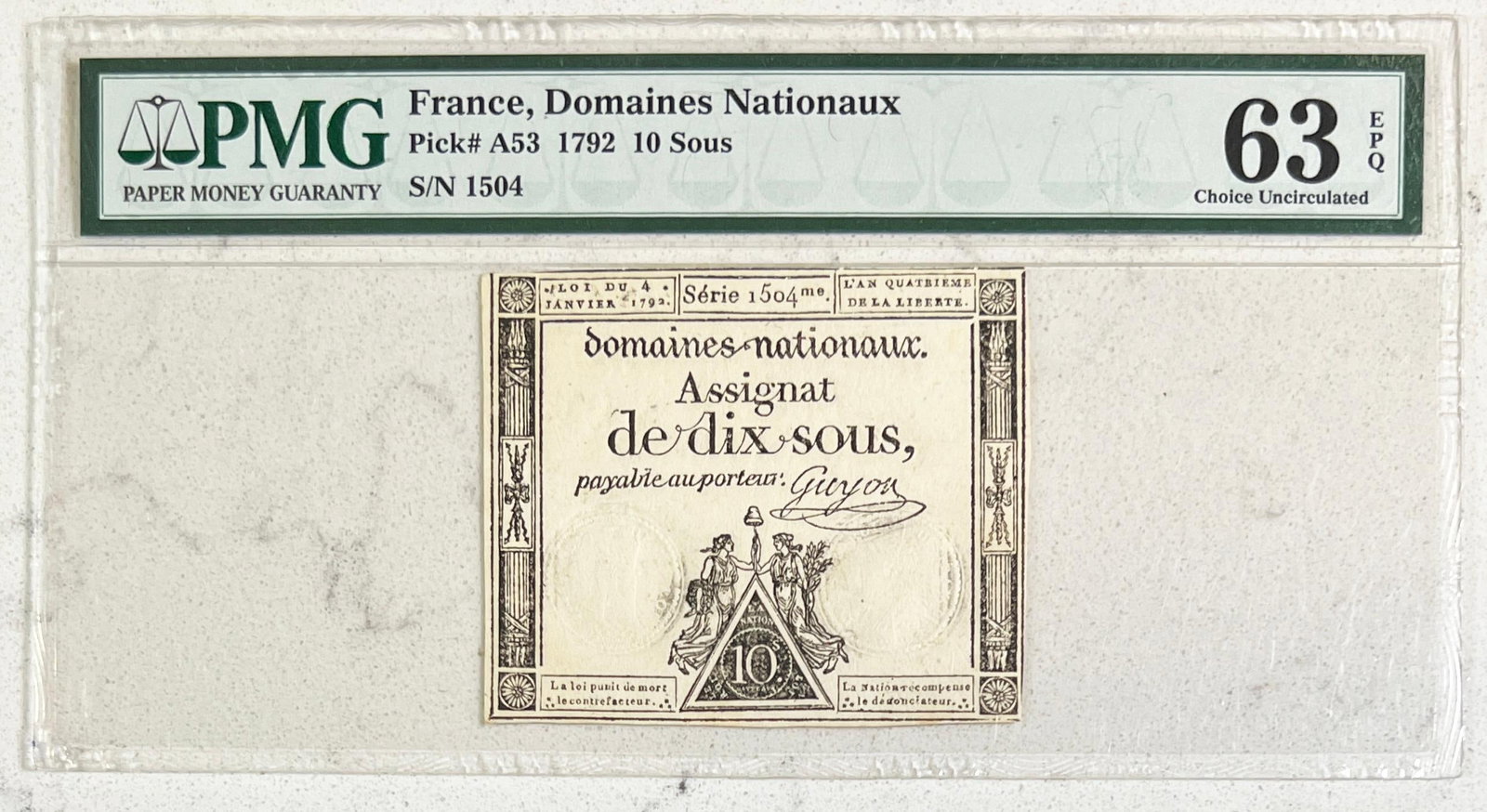 France - Domaines Nationaux 1792 First Issue 10 Sous Bank Note: France 1792 First Issue 10 Sous Domaines Nationaux Bank Note | Pick # A53, Series 1504 me | PMG Graded: 63 epq Choice Uncirculated. Deep and clear embossed seals on brightly watermarked laid paper | N