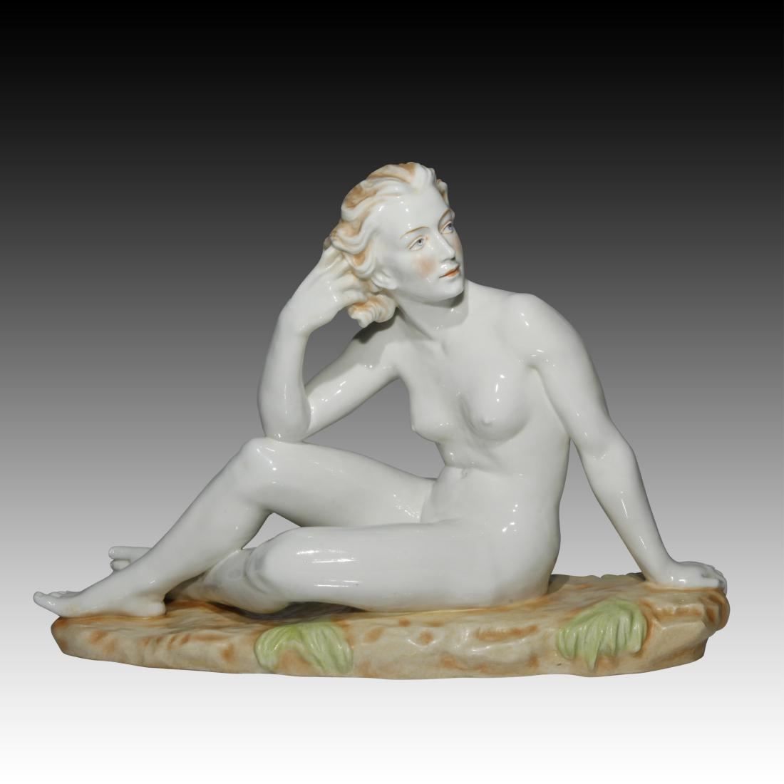 Nude Woman Sitting in a Field Figurine: Nude Woman Sitting in a Field Figurine This is a striking Large figurine by an unknown maker of a Nude Woman, reclining and stroking her blonde hair in the breeze. Marked 12865 along with a blue S tha