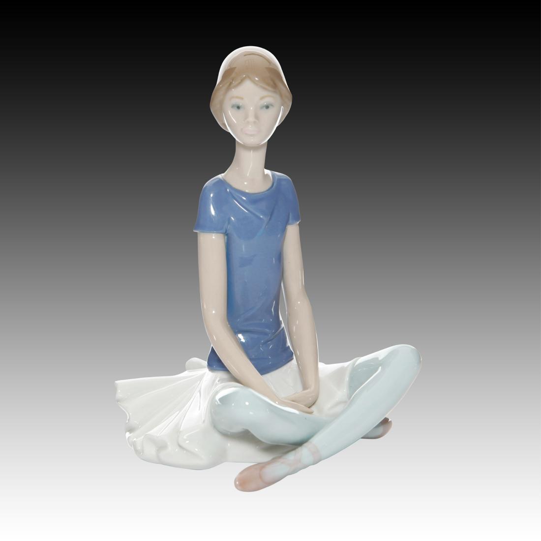 Lladro "Beth" Ballerina Dancer Figurine #1358: Lladro "Beth" Ballerina Dancer Figurine #1358 Lladro # 1358 called Beth, a seated ballerina figurine wearing a blue shirt with light green leggings. Origin: Spain Size: 7.5"H Issued: 20th Century