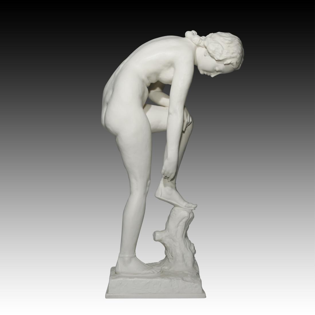 Hutschenreuther Nude Figurine with Bisque Finish: Hutschenreuther Nude Figurine with Bisque Finish Hutschenreuther White bisque finish Large figurine of a young woman putting on her sandal with one foot up on a stump Origin: Germany Size: 18.0" H Iss