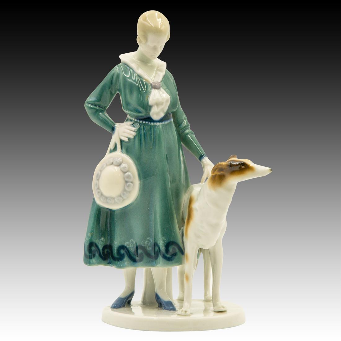 Goebel Lady Borzoi Double Crown Mark Figurine: Goebel Lady Borzoi Double Crown Mark Figurine Woman standing next to a Russian Borzoi Dog. Marked G.F. 822 and has the double crown mark on the underside of base. 1 incised and 1 blue stamped crown. T