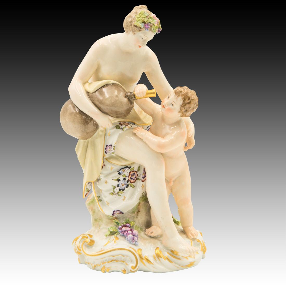 KPM Semi-nude Woman and Child Figurine: KPM Semi-nude Woman and Child Figurine Polychrome figurine of a semi-nude woman and her naked child drinking water from a bladder Origin: Germany Size: 8.0" H Issued: 20th Century
