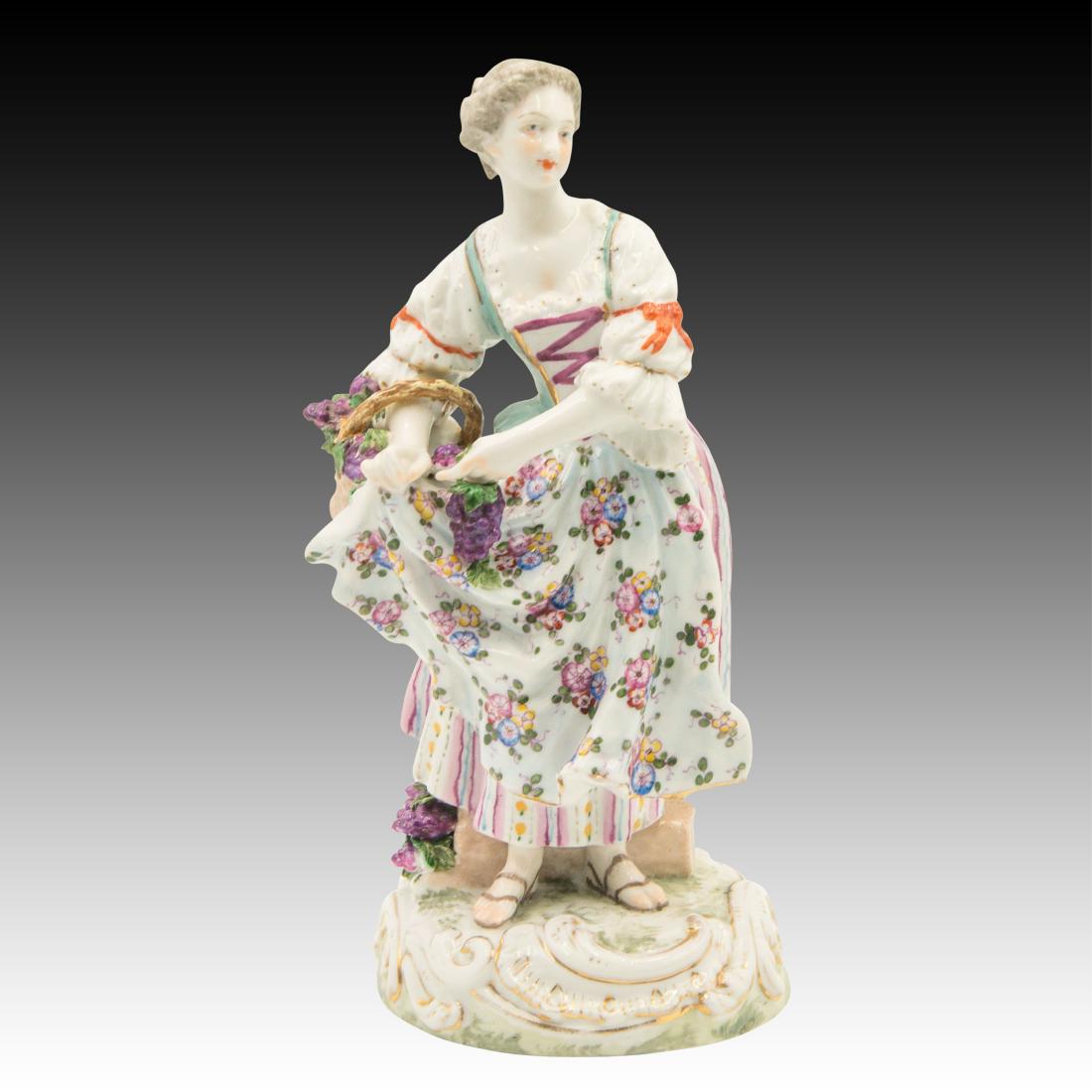 Meissen Young Woman Harvesting Grapes: Meissen Young Woman Harvesting Grapes Young Woman with a basket under her right arm harvesting burgundy grapes to make wine. Crossed swords mark. Origin: Germany Size: 9.25"H Issued: 20th Century