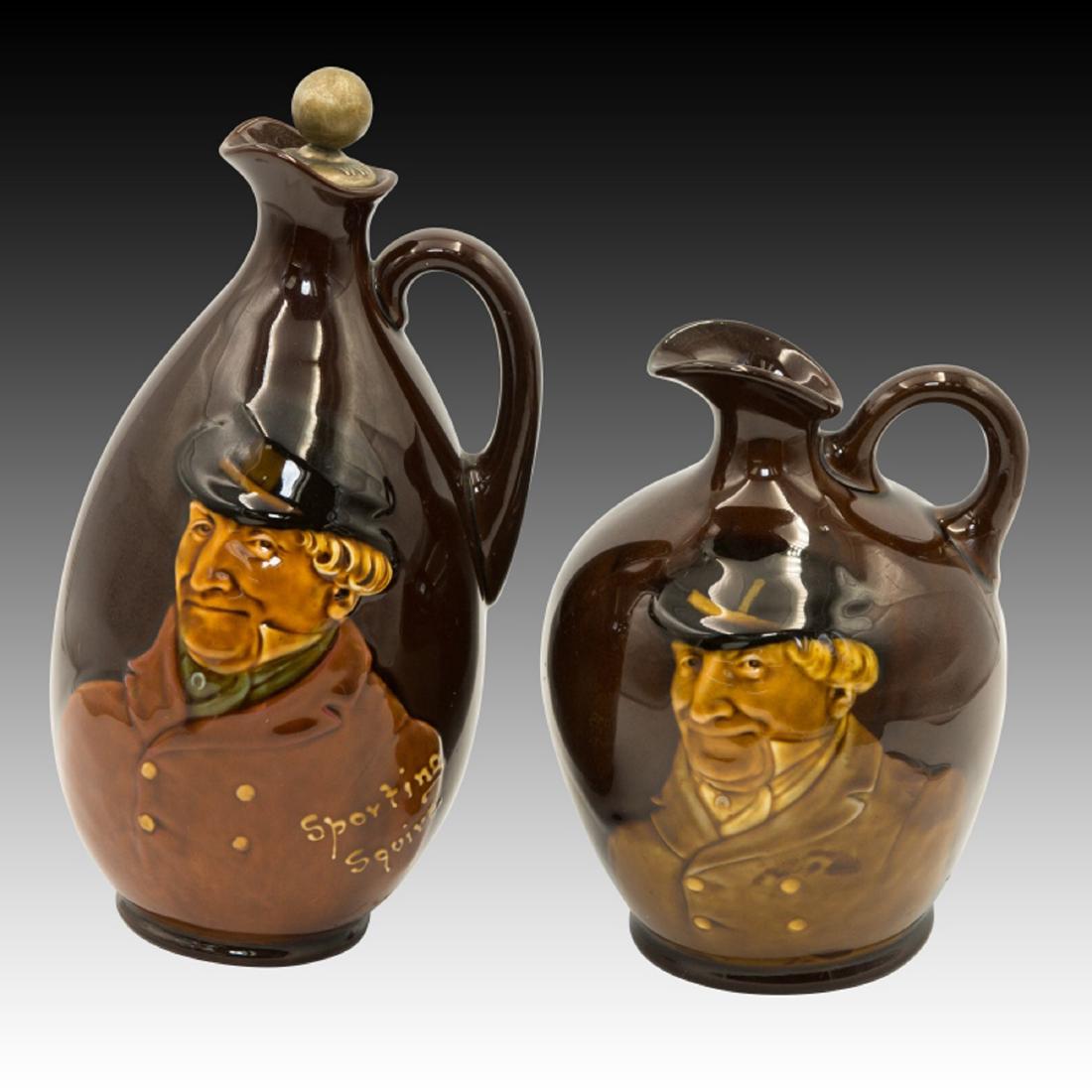 Pair of Doulton Kingsware Dewar's Whisky Flasks: Squire 2 Royal Doulton Dewars Whiskey flasks with the "Sporting Squire" on the front. 1] Tall flask - w/ Dewars stopper and marked Dewars Whiskey next to the back stamp. 8.5??ÂH. 2] Short flask - w/
