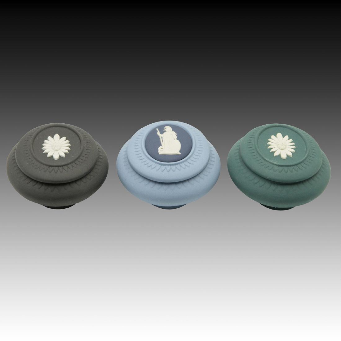 3 Small Oval Wedgwood Jasperware Boxes: 1 - light blue with royal blue medallion, 1 - black basalt and 1 - dark green with white floral center. All marked "Wedgwood Made in England" ; Size: 3"x2.5";
