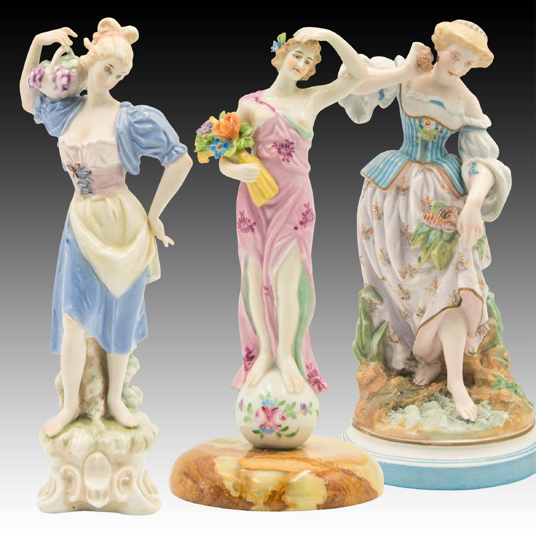 Group of 3 Continental Porceleain Female Figurines: Barefoot young woman carrying a basket of grapes on her shoulders to the Wine Press. 9.5" H Woman listening to the ocean by holding a seashell to her ear. She is also holding a grouping of different s