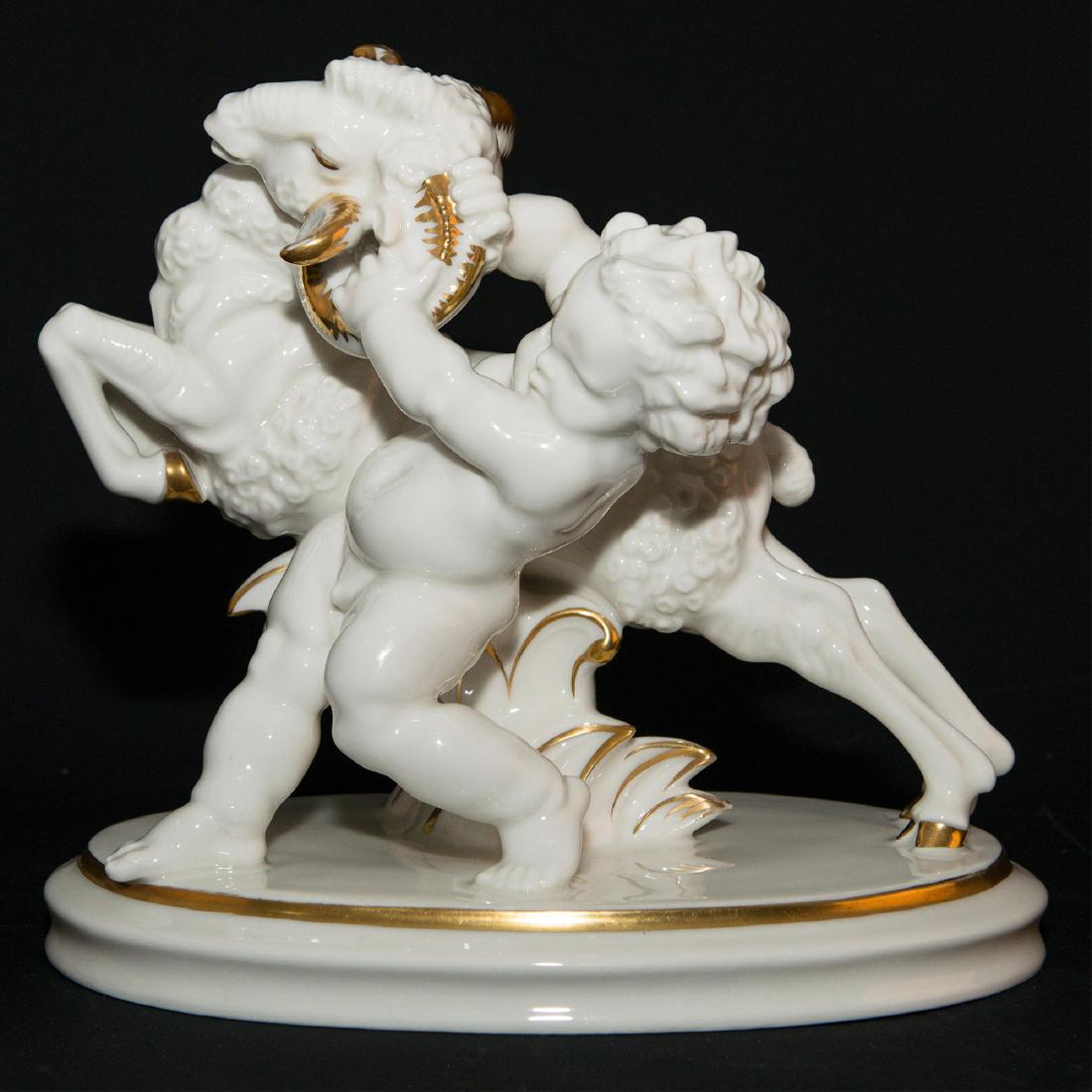 Hutschenreuther Porcelain Sculpture Figurine: Hutschenreuther Porcelain Sculptural Group Figurine of a Cherub fighting ram designed by Karl Tutter. Circa 1920s. Signed on the base and marked on the bottom. 11"L x 10"H x 7"W =; Country of Origin: 