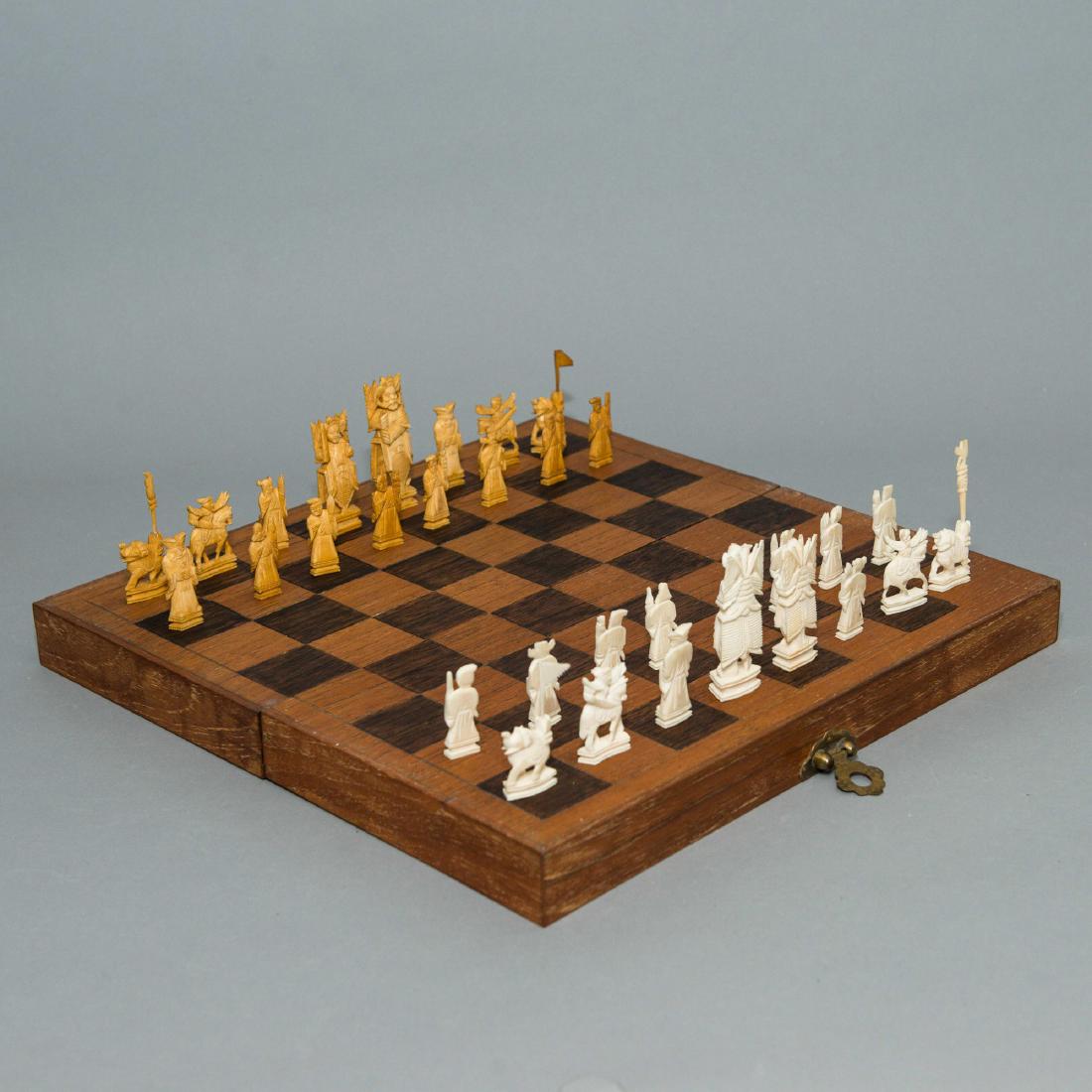 Traditional Asian Hand Carved Chess Set: An Asian chess set, with 16 wood and ivory colored hand carved chess pieces. The inside of the portable chess board is lined with royal blue felt. The clasp is Asian style brass. Chess is believed to
