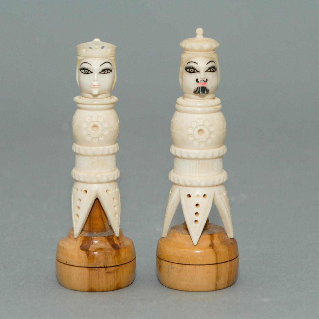 Carved Bone & Wood Chess Pieces: Two vintage carved bone chess pieces with hand painted faces in the style of playing card portraits, with wood bases. The King is 5.5" Long, the Queen 5.25" ; Issued: ca. 1960;