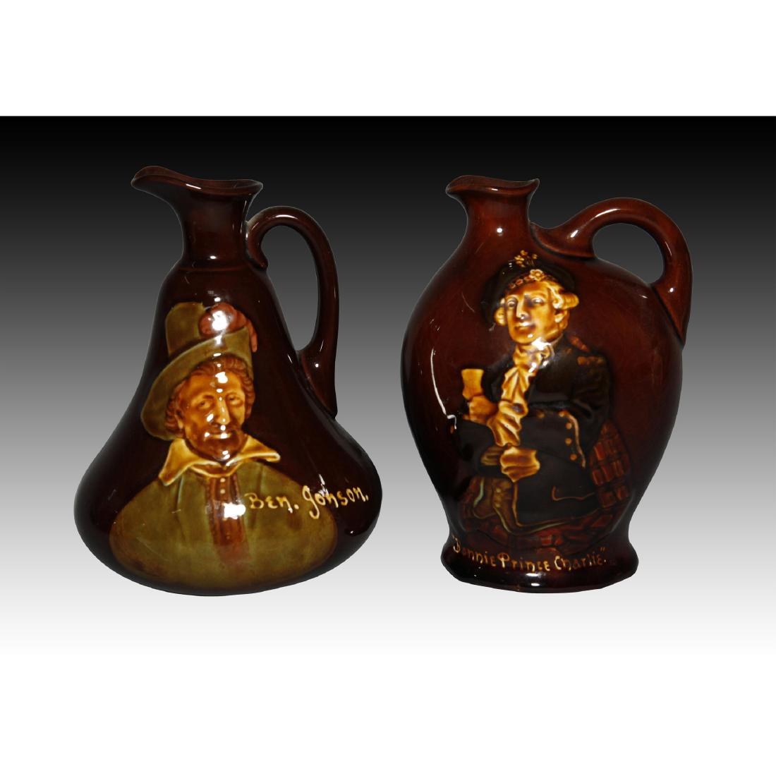 Royal Doulton 2 Kingsware Dewars Whiskey Jugs: Two Dewars Whiskey Kingsware jugs. 1. Bonnie Prince Charlie circa 1912 7.0"H 2. Ben Johnson circa 1909 7.0"H Both are marked on the bottom with the Doulton back stamp along with a Dewars Whiskey stamp