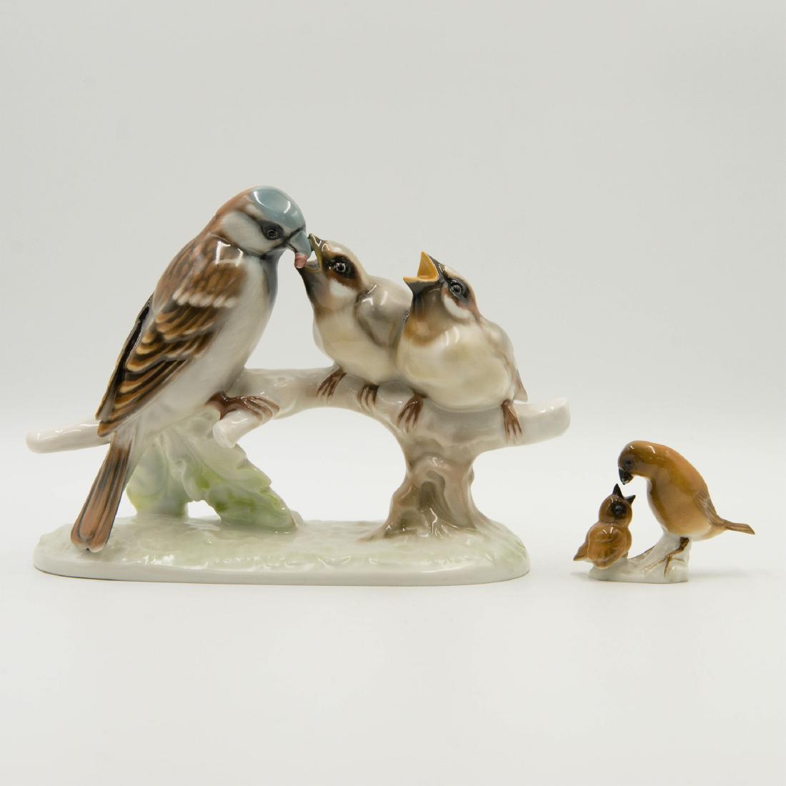 GROUP OF 2 HUTSCHENREUTHER BIRD FIGURINES: Group of 2 Hutschenreuther porcelain figurines. Miniature figurine of a bird feeding baby designed by Karl Tutter 3"L x 2"H x 1"W Large grouping of three birds 8.5"L x 6"H x 3.5"W Circa early 20th cen