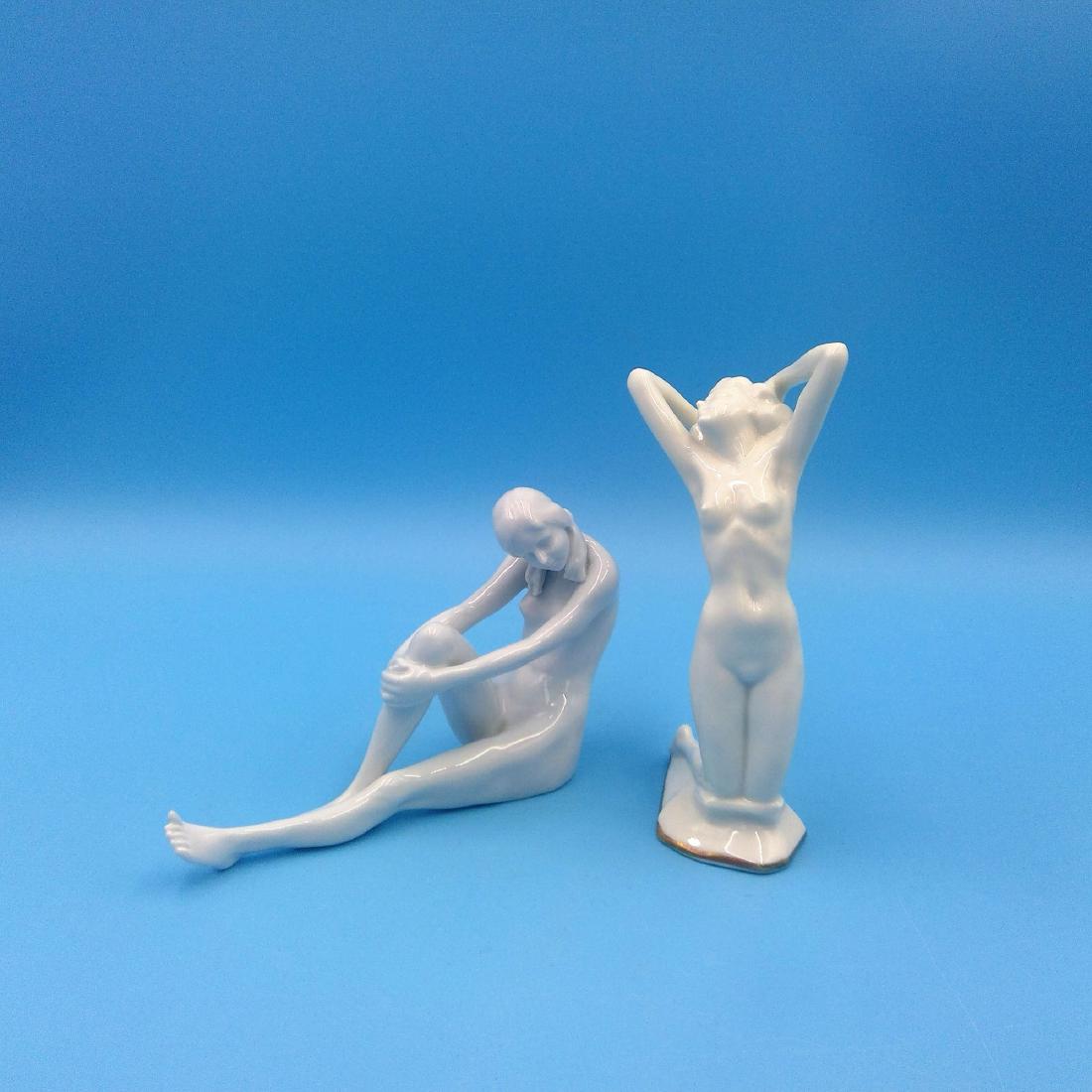 GROUP 2 ROSENTHAL & HUTSCHENREUTHER NUDE FIGURINES: Group of 2 Porcelain Figurines of Nude Women by Rosenthal Selb Bavaria (5"L x 4"H x 1.5"W) and Hutschenreuther Kunstabteilung designed by Karl Tutter (5.5"H x 2.5"L x 2.5"W). Circa 1930s. ; Country of