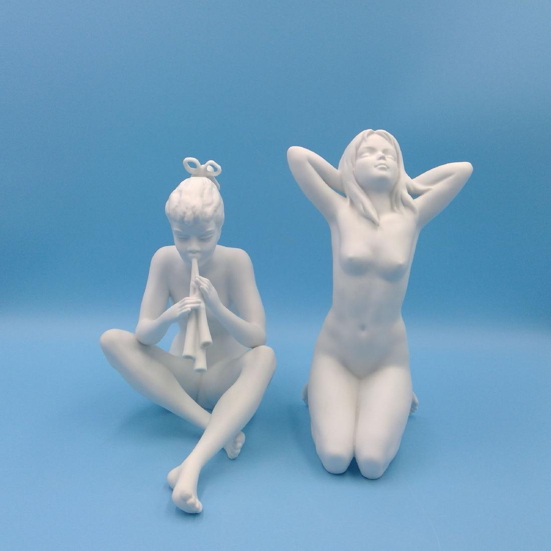 GROUP OF 2 KAISER GERMAN PORCELAIN NUDE FIGURINES: Group of 2 Kaiser White Porcelain Figurines: 1) Nude woman playing flute (7.5"H x 8"L x 5"W) 2) Nude lady (8"H x 4.5"L x 4"W). Circa mid 20th century. ; Country of Origin: Germany;