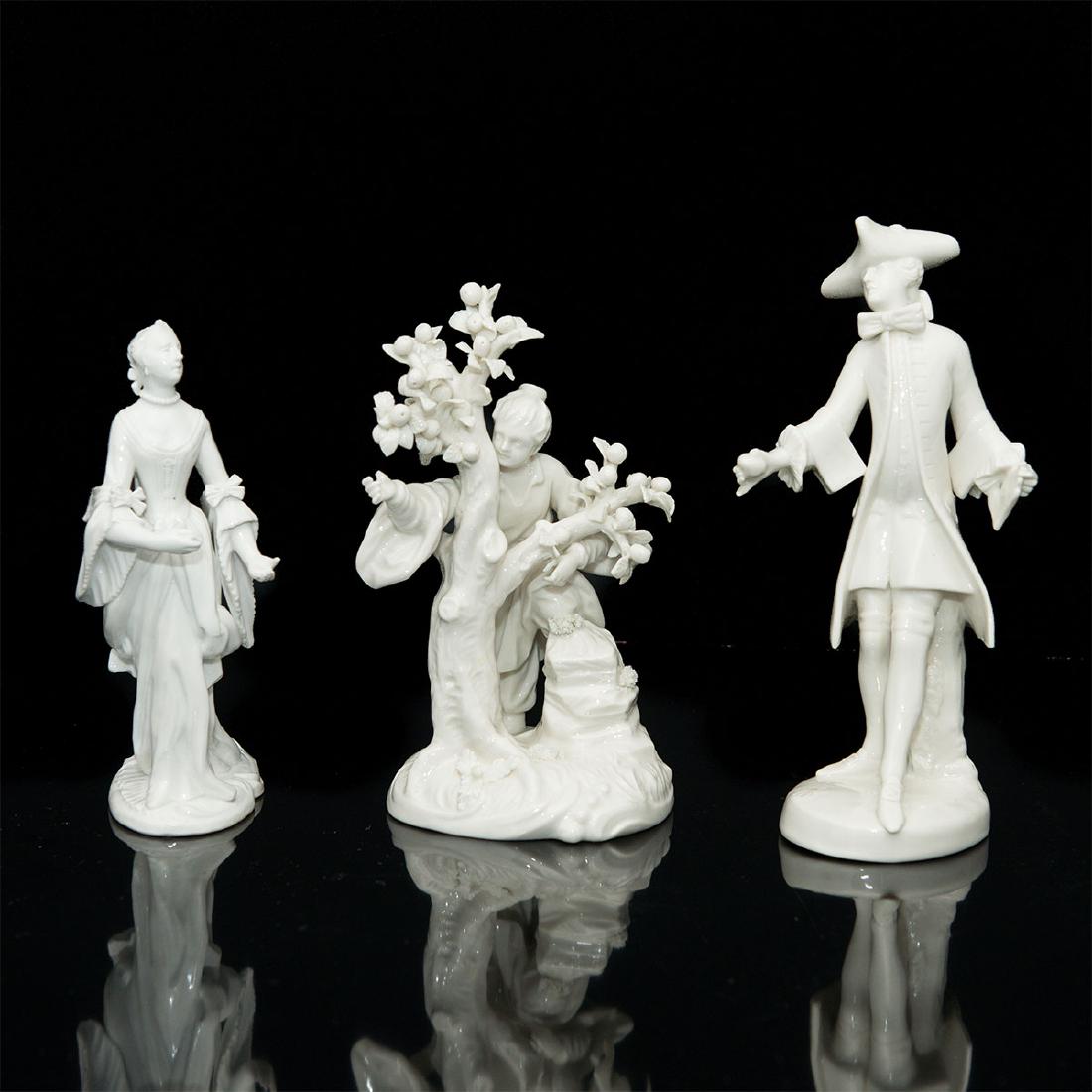 GROUP OF 3 NYMPHENBURG PORCELAIN FIGURINES: Group of 3 Nymphenburg Blanc de Chine Figurines. Lady picking apples (7"H x 3.75"D), model number 1173a, has chips on the leaves and on the finger. Man with a glove (7.5"H x 3"L x 2.75"W), model numbe