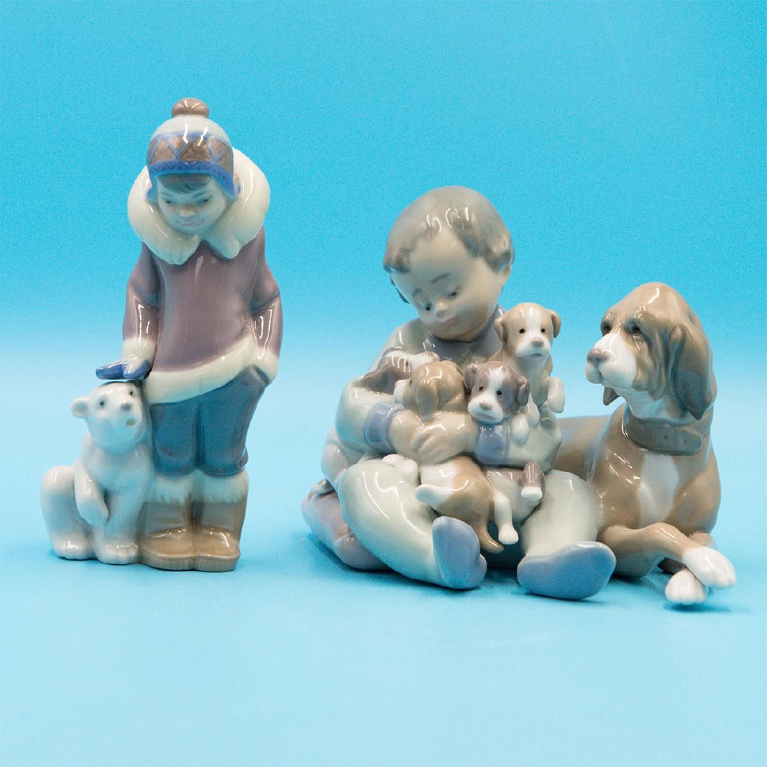 LLADRO NEW PLAYMATES AND ESKIMO BOY WITH PET: Two Lladro Porcelain figurines of children and their pets: Eskimo Boy with Pet 0100538 - (6"H x 2.5"W) An Eskimo boy poses with a polar bear cub - Lilac, Blue, White. New Playmates 01005456 - (5"H x 6