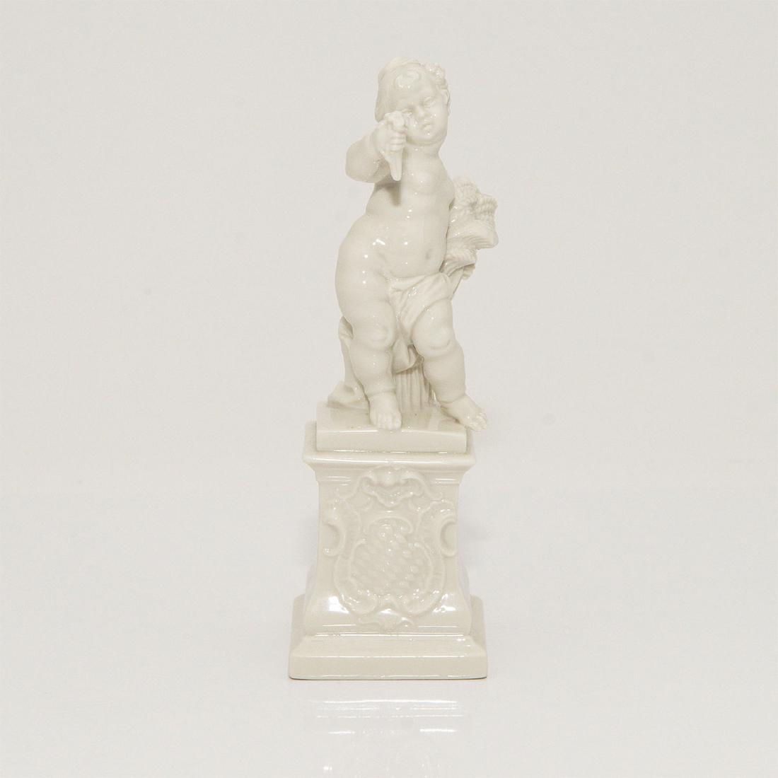 NYMPHENBURG PORCELAIN FIGURINE CHERUB: Nymphenburg Blanc de Chine Figurine of a Putti on a Pedestal, from the Four Seasons Series. Allegory of Summer. Model number 265a/3. Circa1900s. Artist: Franz Anton Bustelli; Country of Origin: German